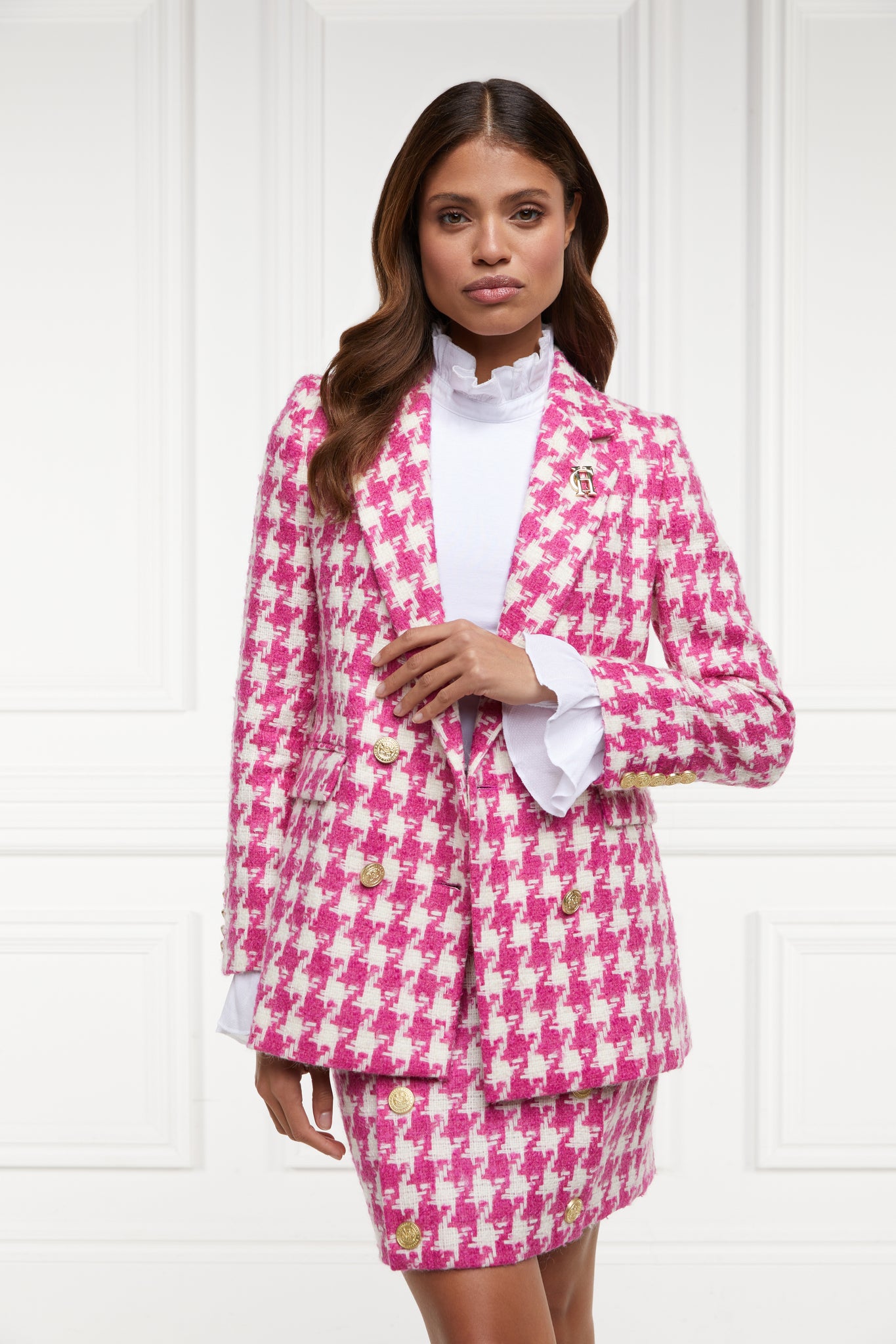 double breasted wool blazer in hot pink large scale houndstooth with two hip pockets and gold button detials down front and on cuffs and handmade in the uk