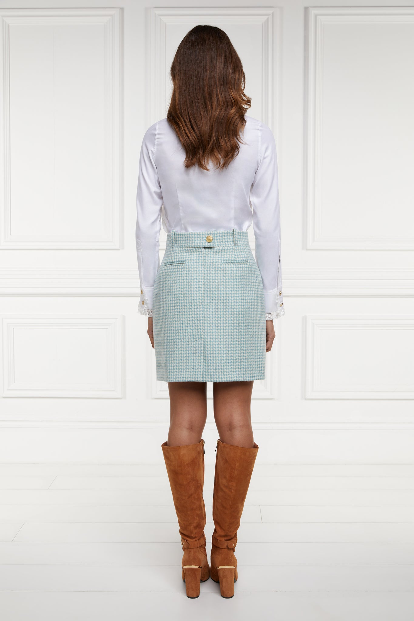 back of womens light blue and white houndstooth wool pencil mini skirt with concealed zip fastening on centre back and gold rivets down front