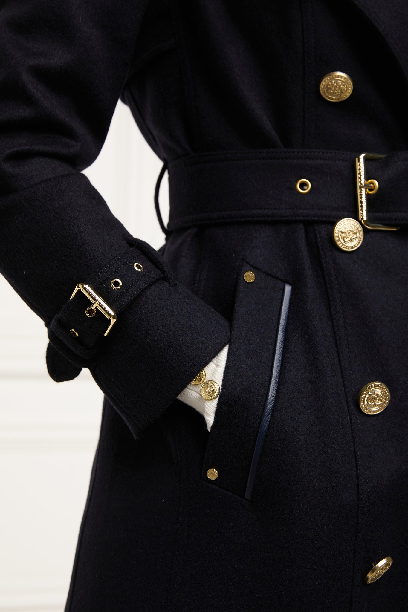 cuff and pocket detail of womens navy wool double breasted trench coat
