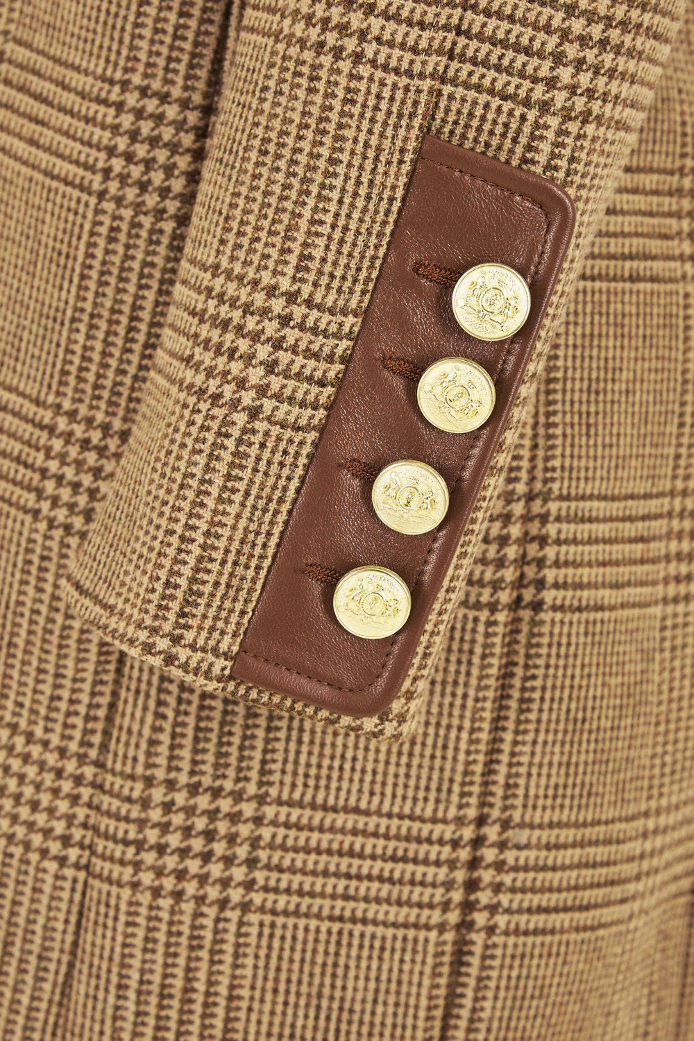 sleeve detail of tan brown tweed womens coat with gold hardware and brown suede detailing