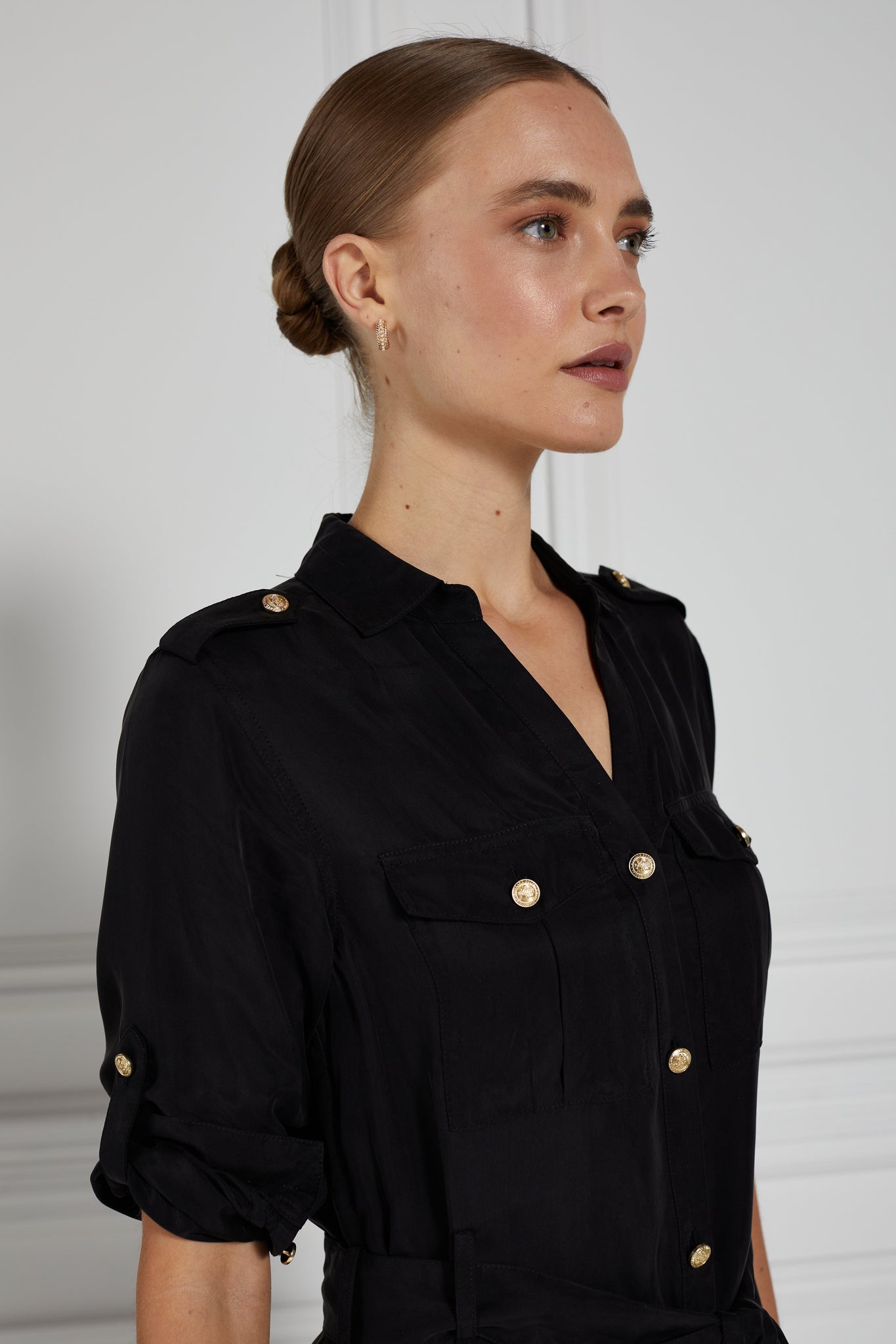 zoomed in side shot of womens black military midi shirt dress with tie around waist and gold buttons down the front