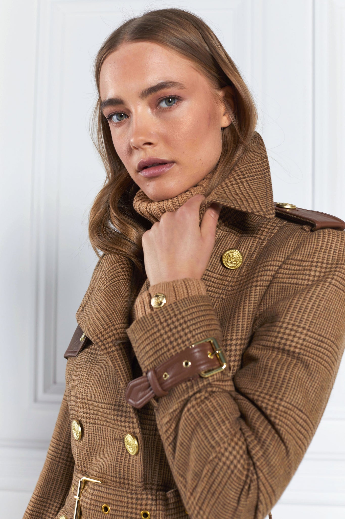 Detail of womens tawny light tan detailed with gold hardware knee length wool trench coat