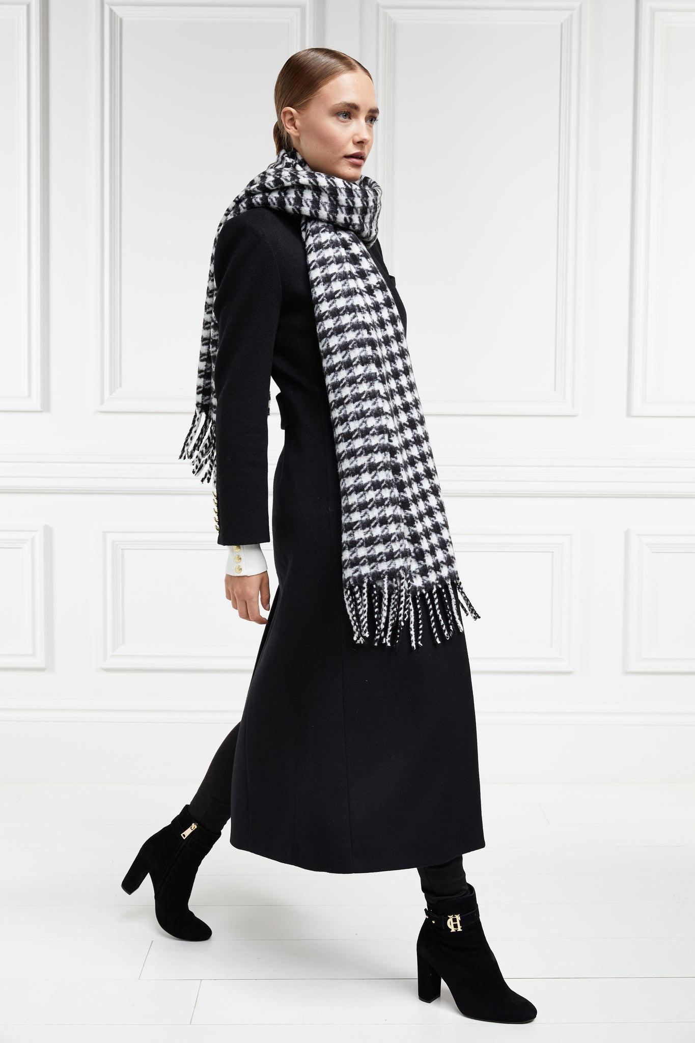 black single breasted full length wool coat with black and white houndstooth wool scarf