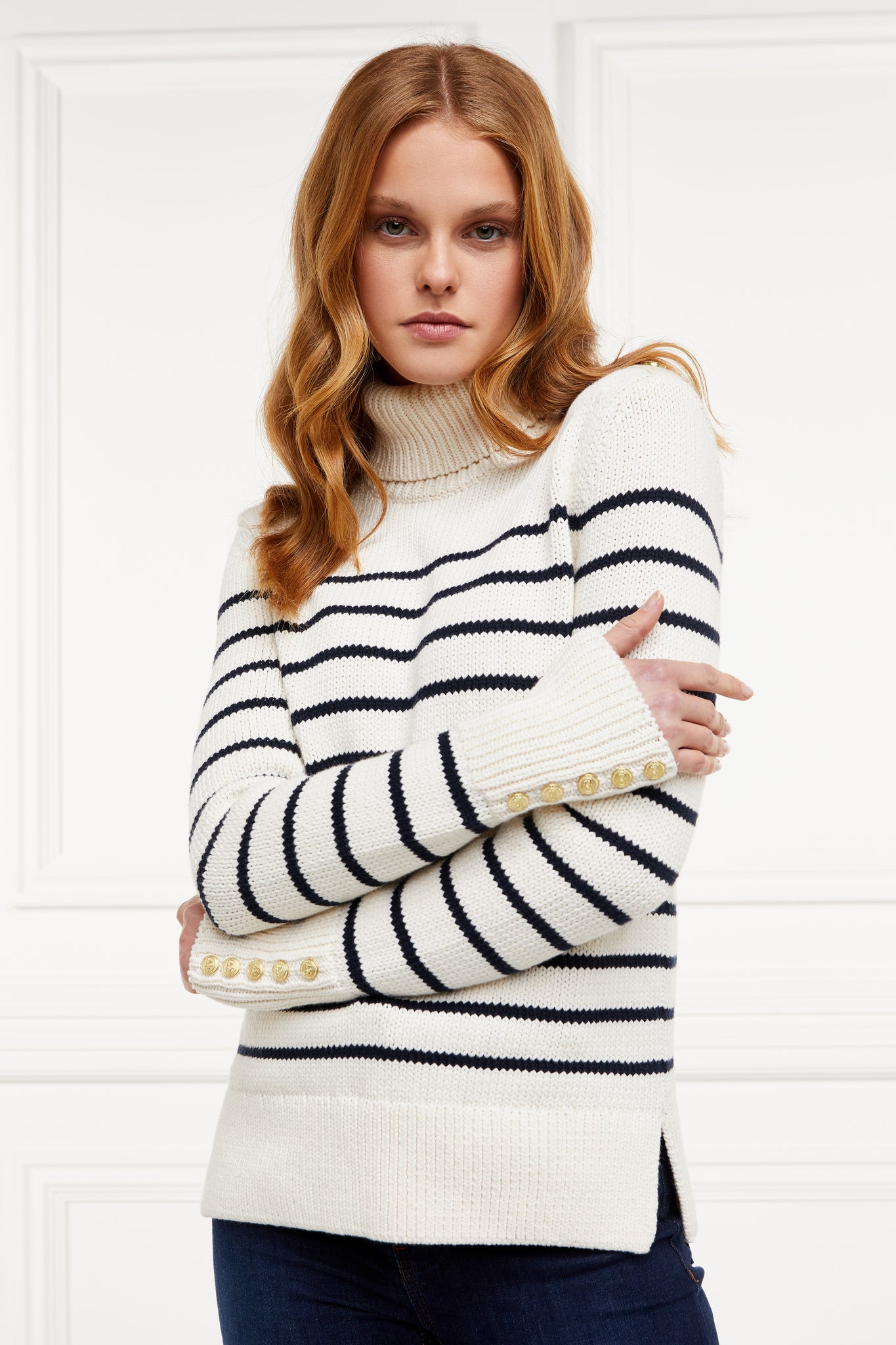 a classic cream and navy breton stripe roll neck jumper with a split ribbed hem and gold button detail on the cuffs and collar