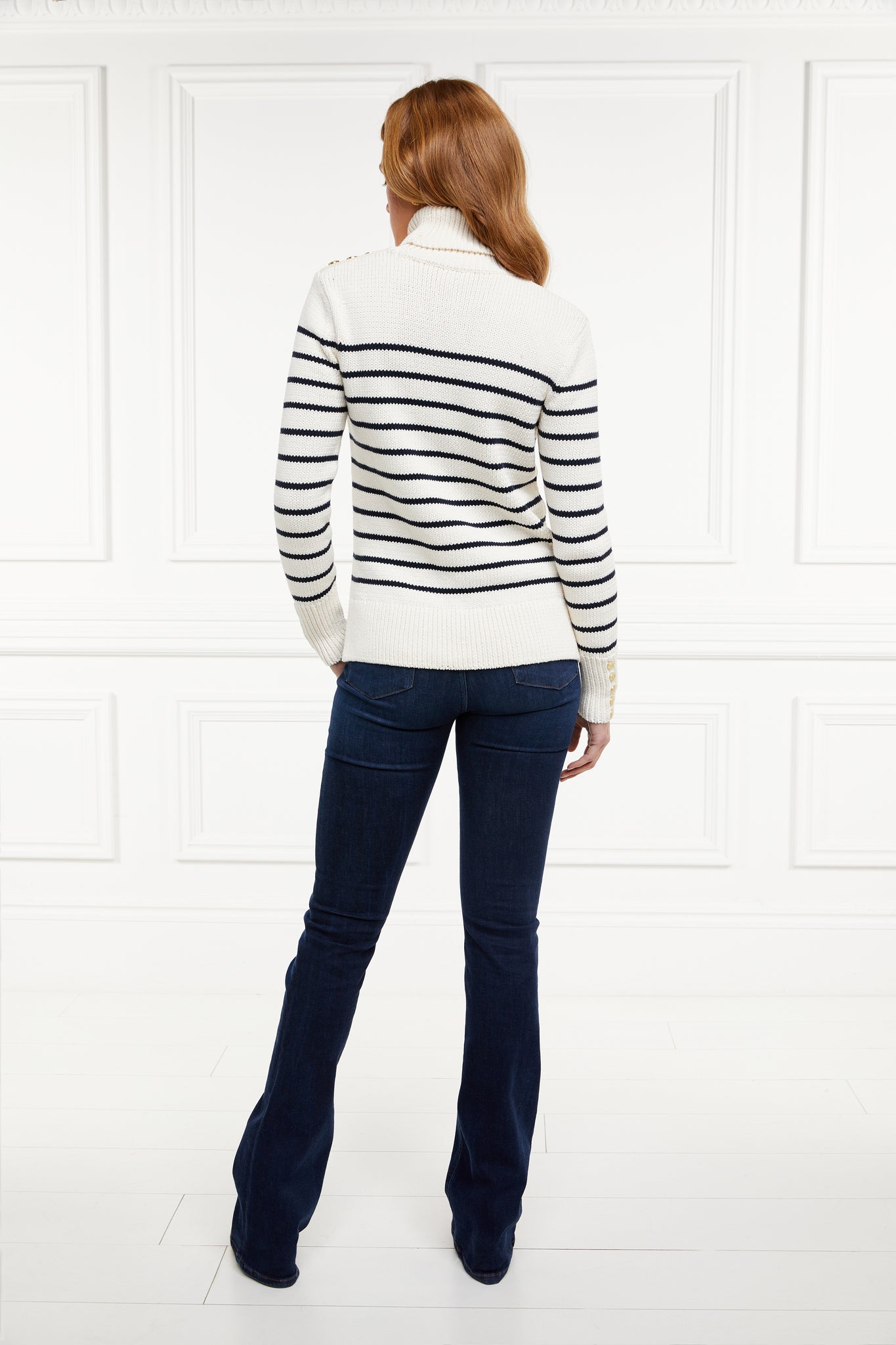 a classic cream and navy breton stripe roll neck jumper with a split ribbed hem and gold button detail on the cuffs and collar
