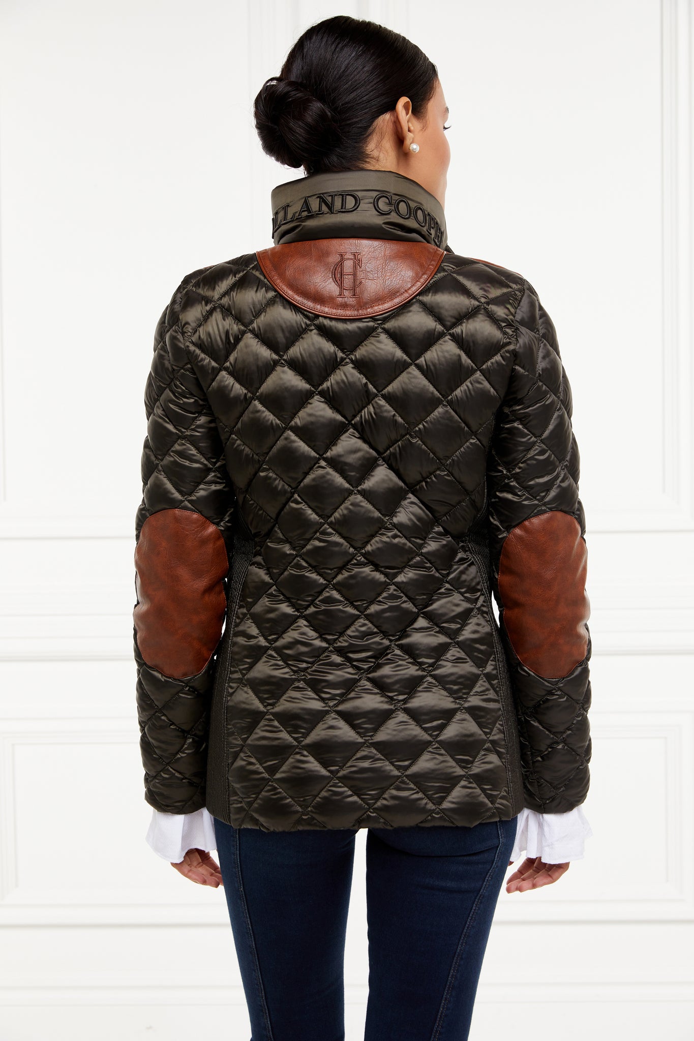 back of womens diamond quilted khaki jacket with contrast tan leather elbow and shoulder pads large front pockets and shirred side panels