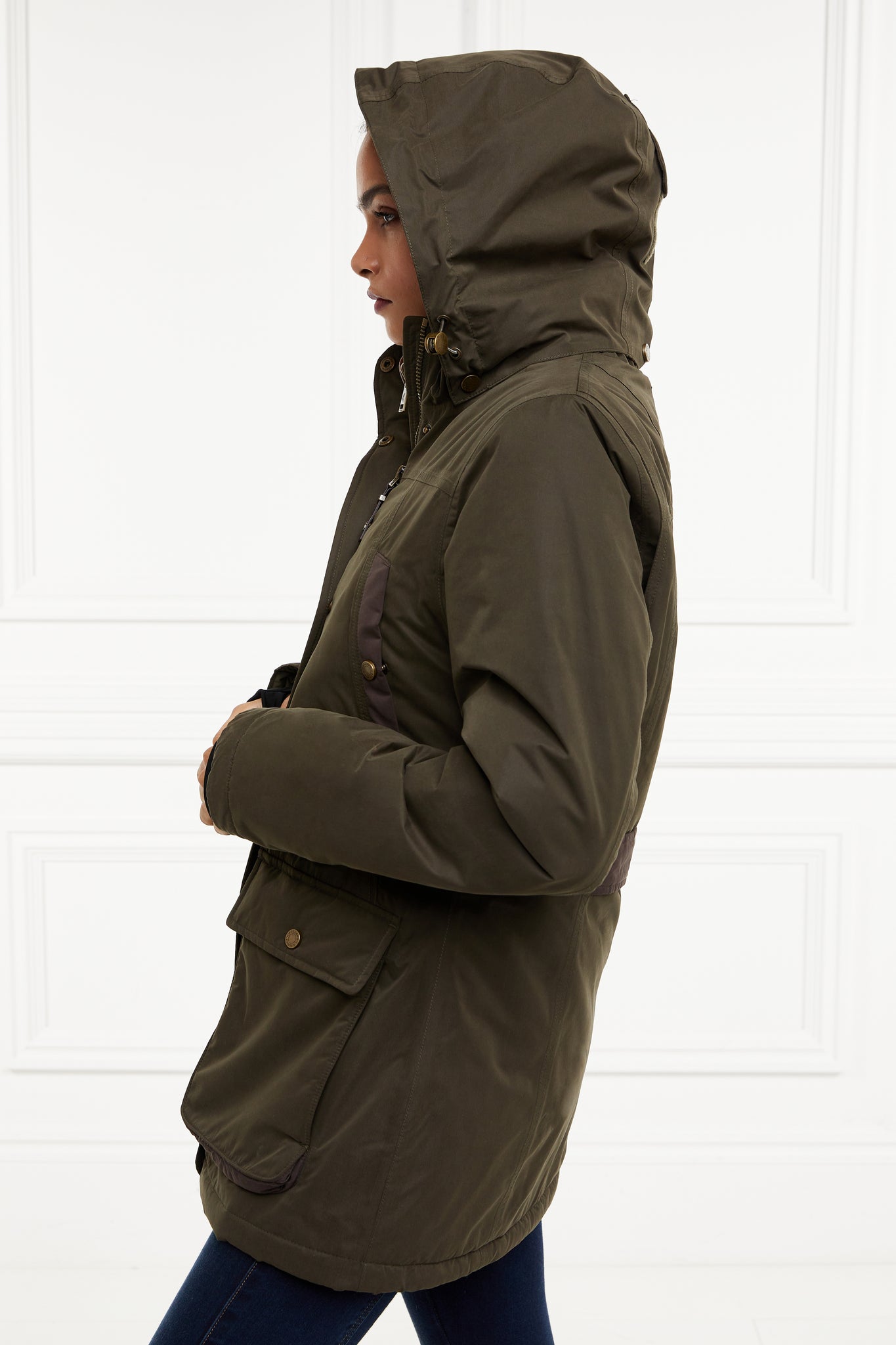 side of multiway coat in khaki that works as a 3 in 1 a waterproof outer coat with stowaway hood and deep pockets and black jersey storm cuffs and a fleece gilet inner with tan leather trims can be worn together or separately