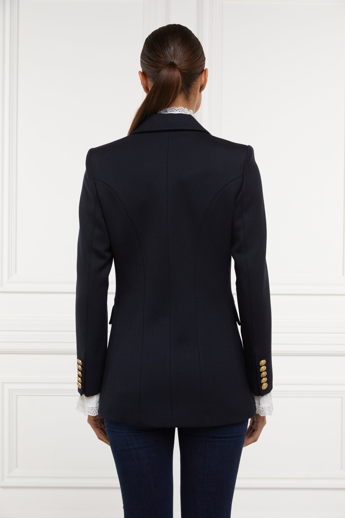 back of double breasted wool blazer in navy twill with two hip pockets and gold button detials down front and on cuffs and handmade in the uk