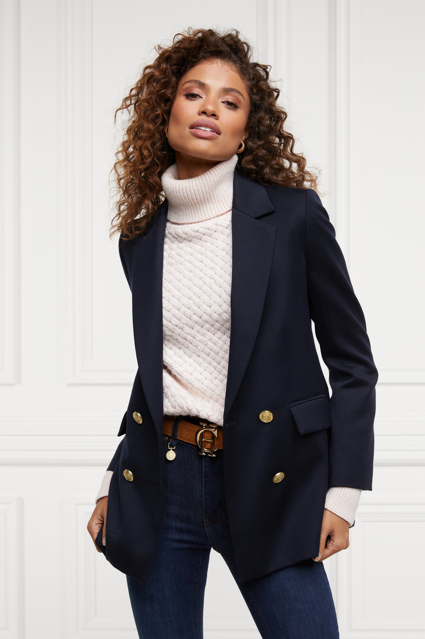 womens lightweight roll neck basket weave knit jumper in powder pink layered under a double breasted blazer in navy