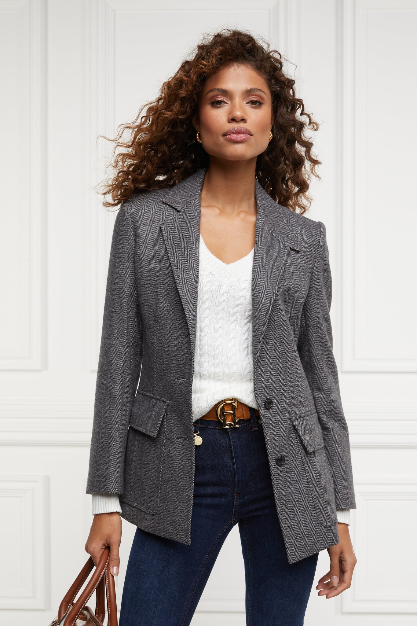 womens lightweight v neck cable knit jumper in white detailed with gold buttons at the cuffs worn under a grey herringbone single breasted blazer