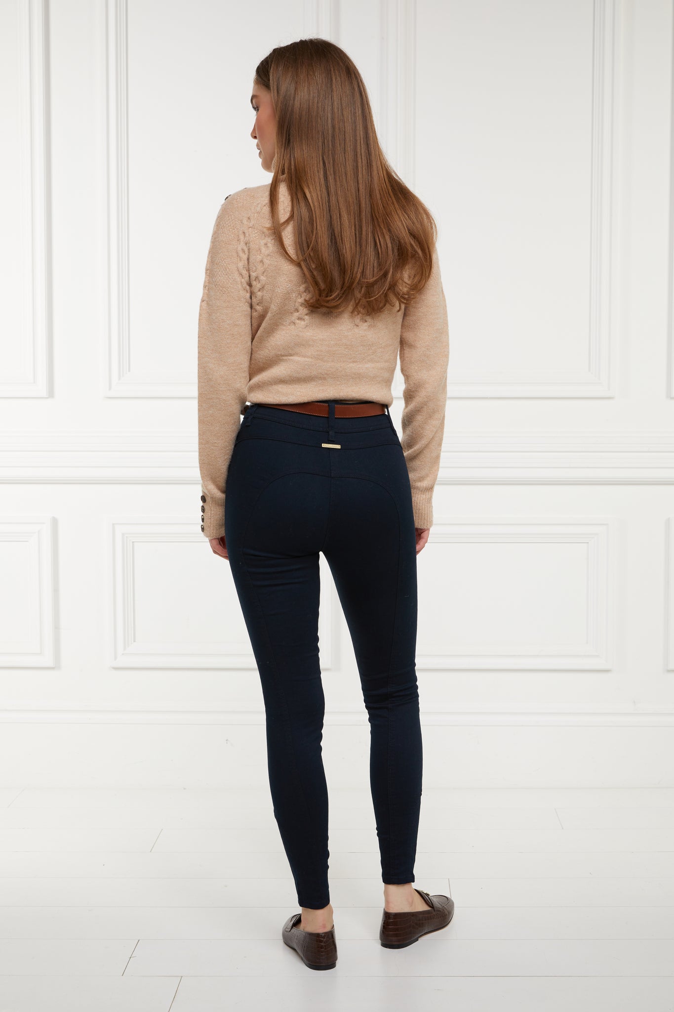 back of womens high rise navy denim skinny stretch jean with jodhpur style seams and two open pockets to the front with hc embroidery on front left pocket