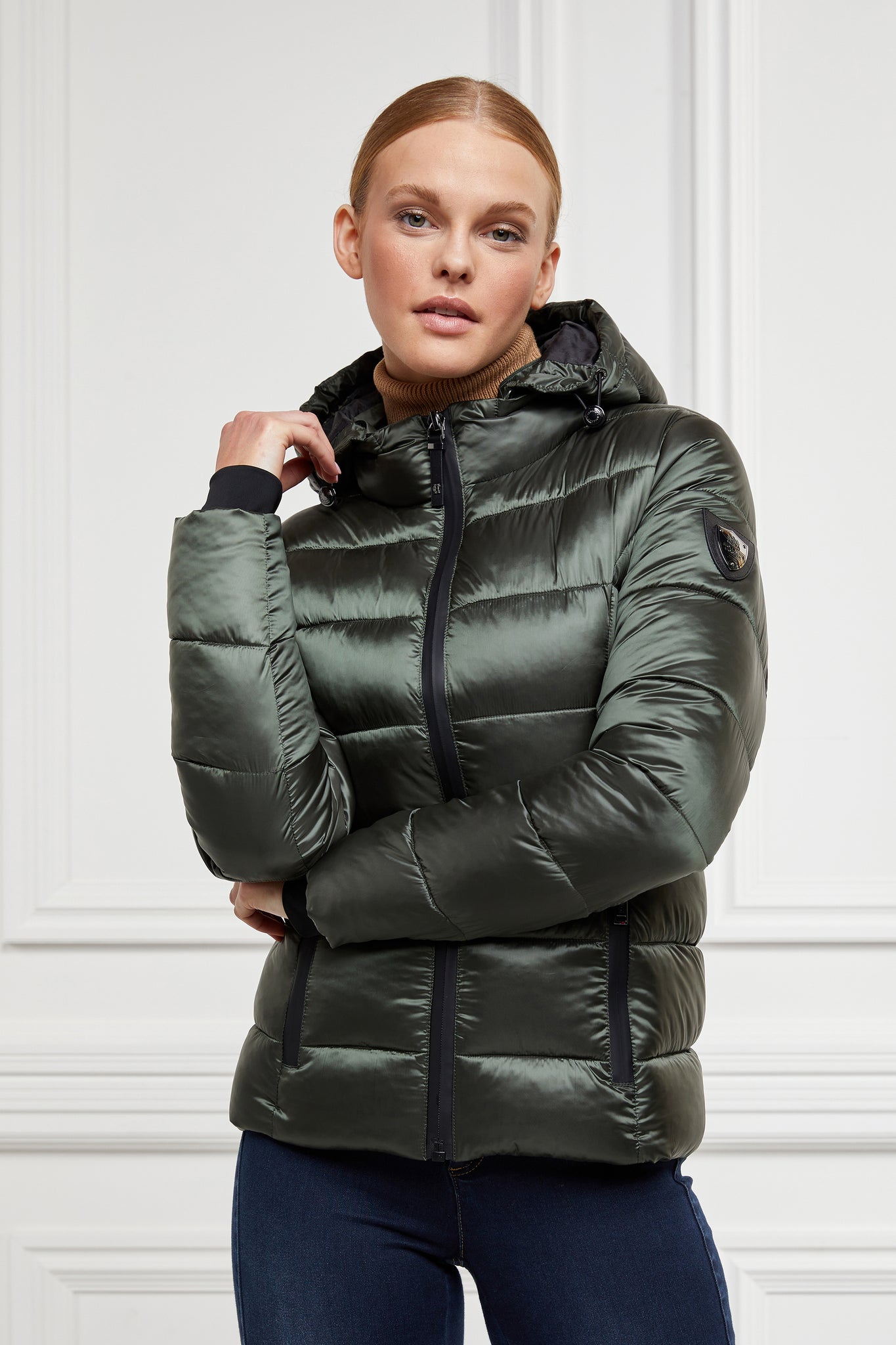 womens slim fit lightweight padded in khaki with removable hood and coated exterior zips and gunmetal shield detail on sleeve