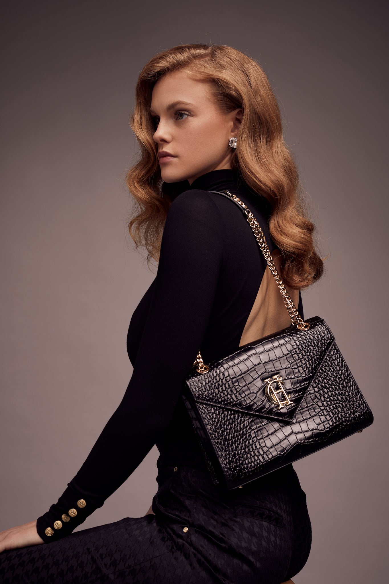 womens black open back bodysuit with grey houndstooth jacquard chinos and black croc embossed leather shoulder bag with gold hardware and chain