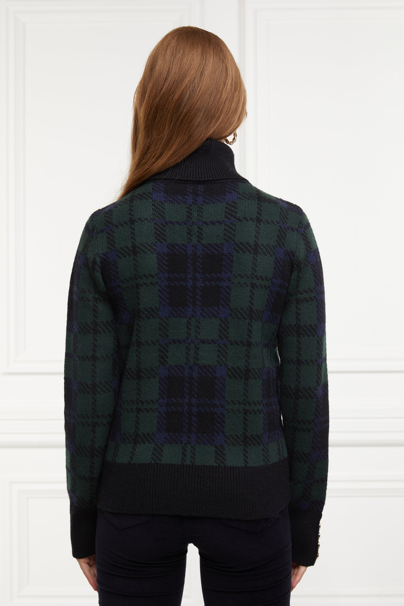 back of womens classic green navy and black blackwatch jumper with contrast black cuffs, roll neck and split ribbed hem with gold button detail on the cuffs and collar