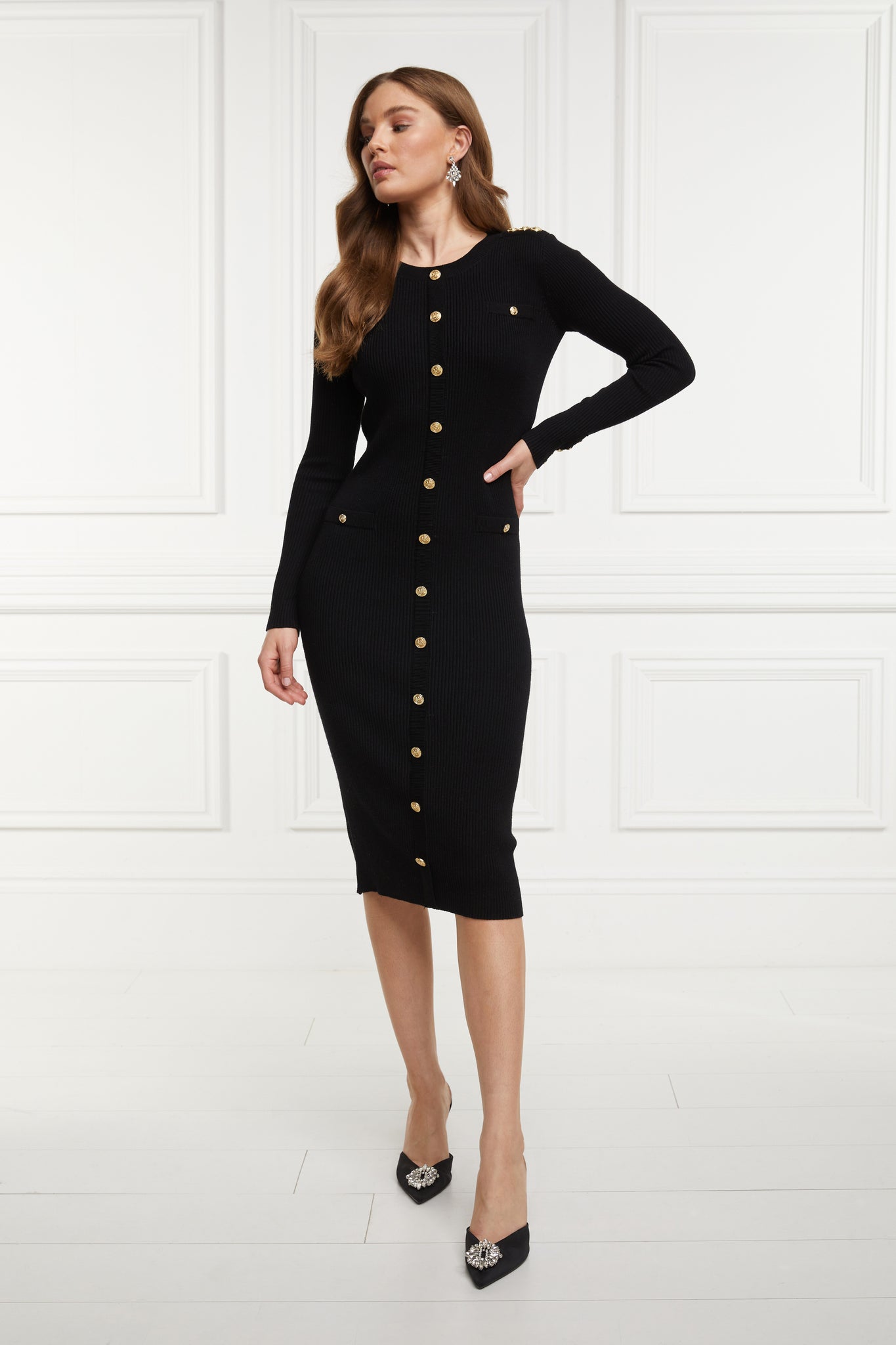 womens slim fit crew neck long sleeve knitted midi dress in black with gold button detail down the centre front and two welt pockets on chest and two on the hips with gold buttons on the centre of each pocket