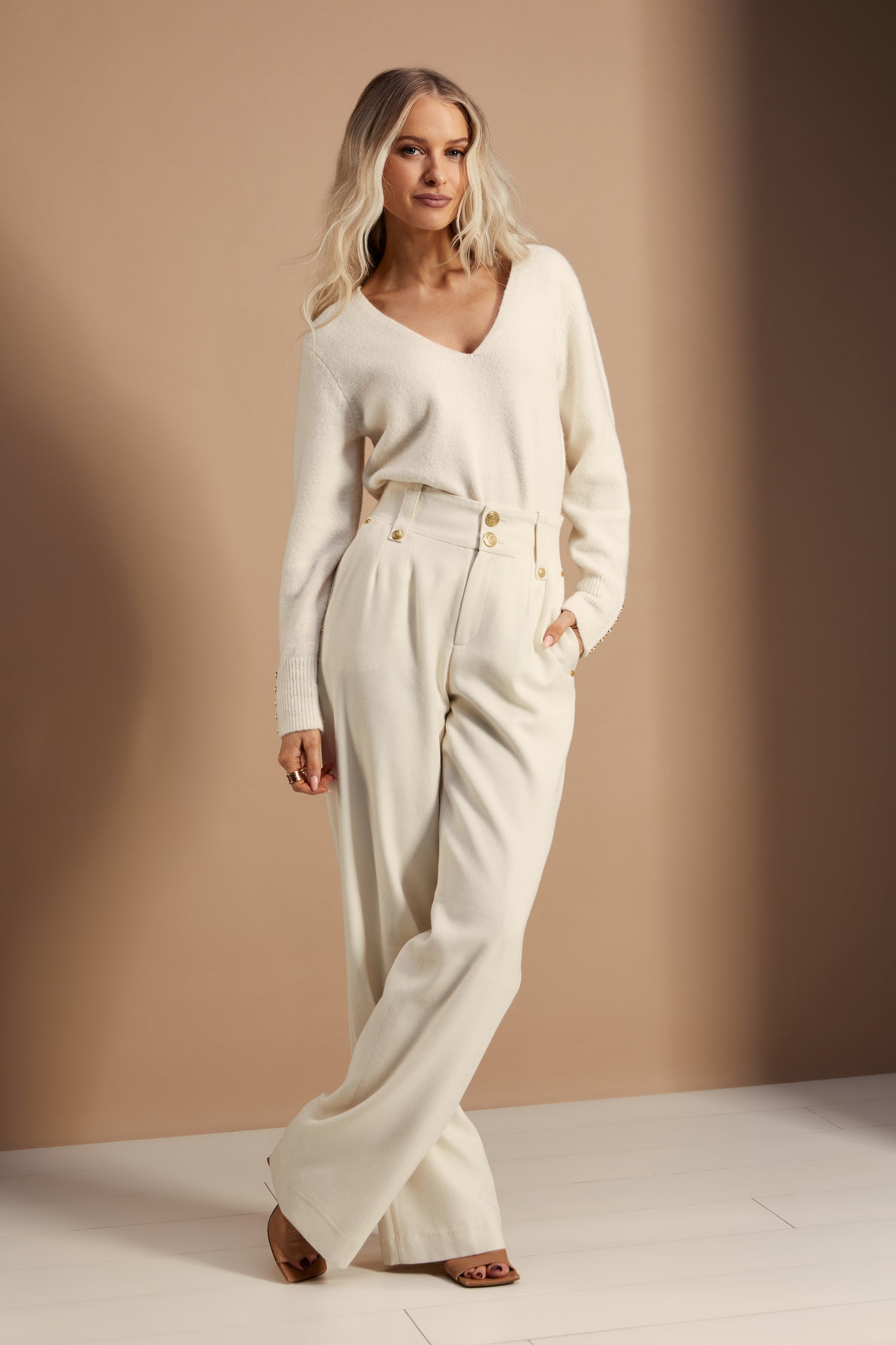 Women’s ivory wool high waisted straight trousers with wool v neck knitted top 