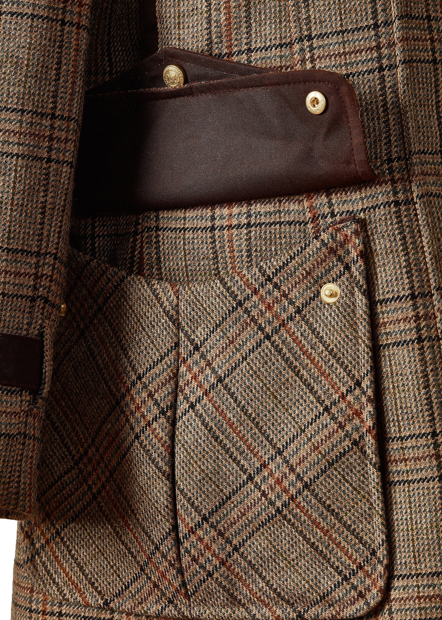 Open pocket detail of womans brown tartan tweed field coat