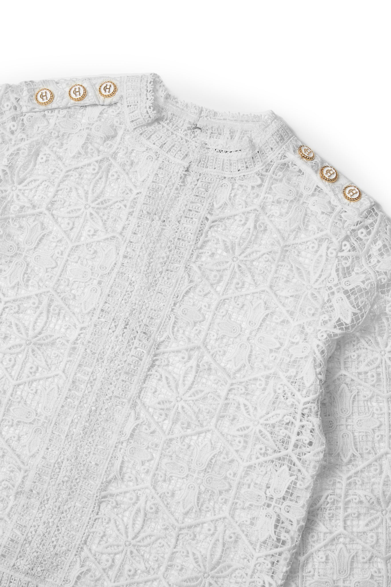 detail of lace crew neckline and holland cooper hardware on the shoulders