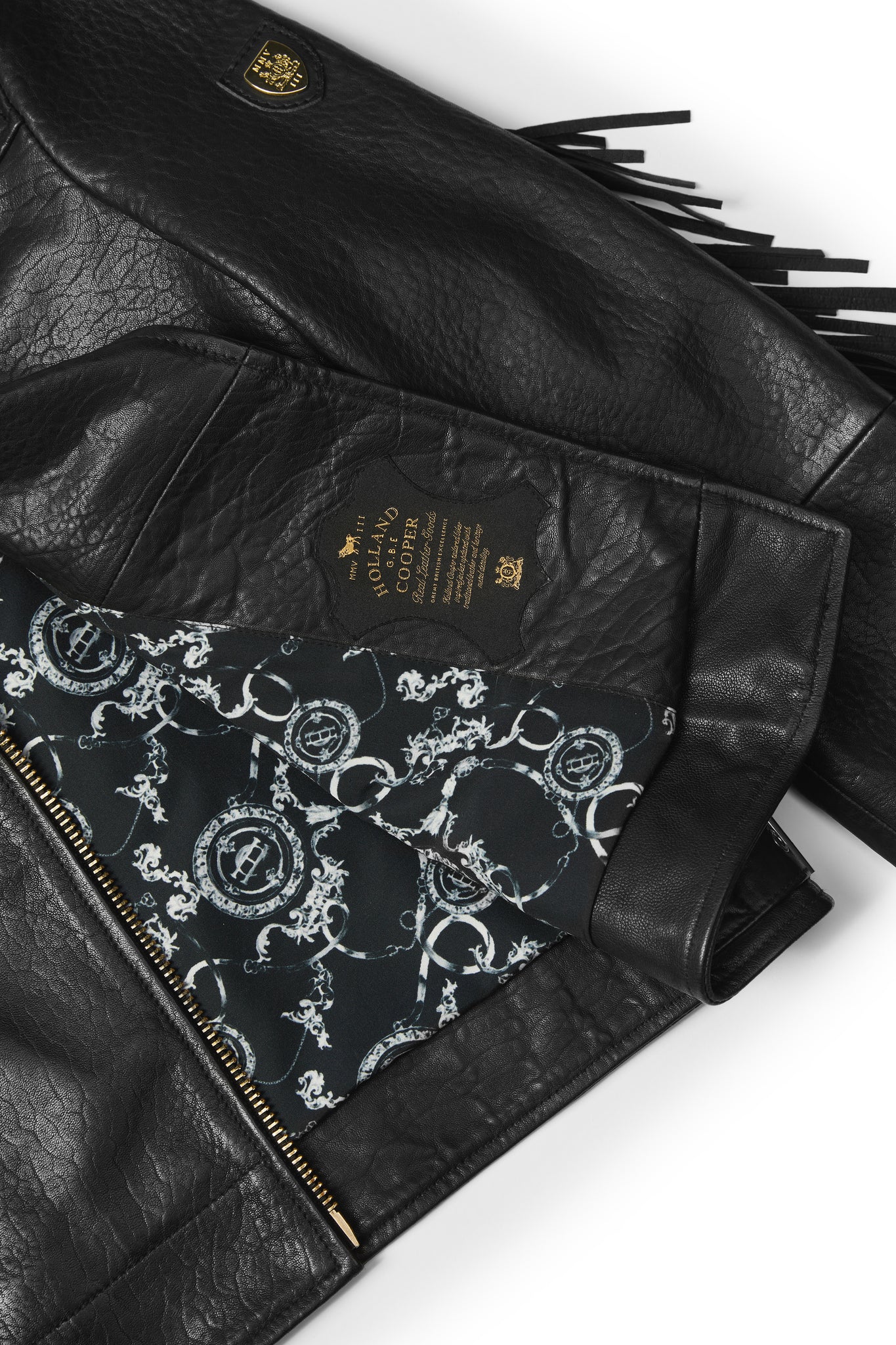 lining detail on womens leather biker jacket in black with fringing along the back and sleeves detailed with golf zips and small shield badge on arm