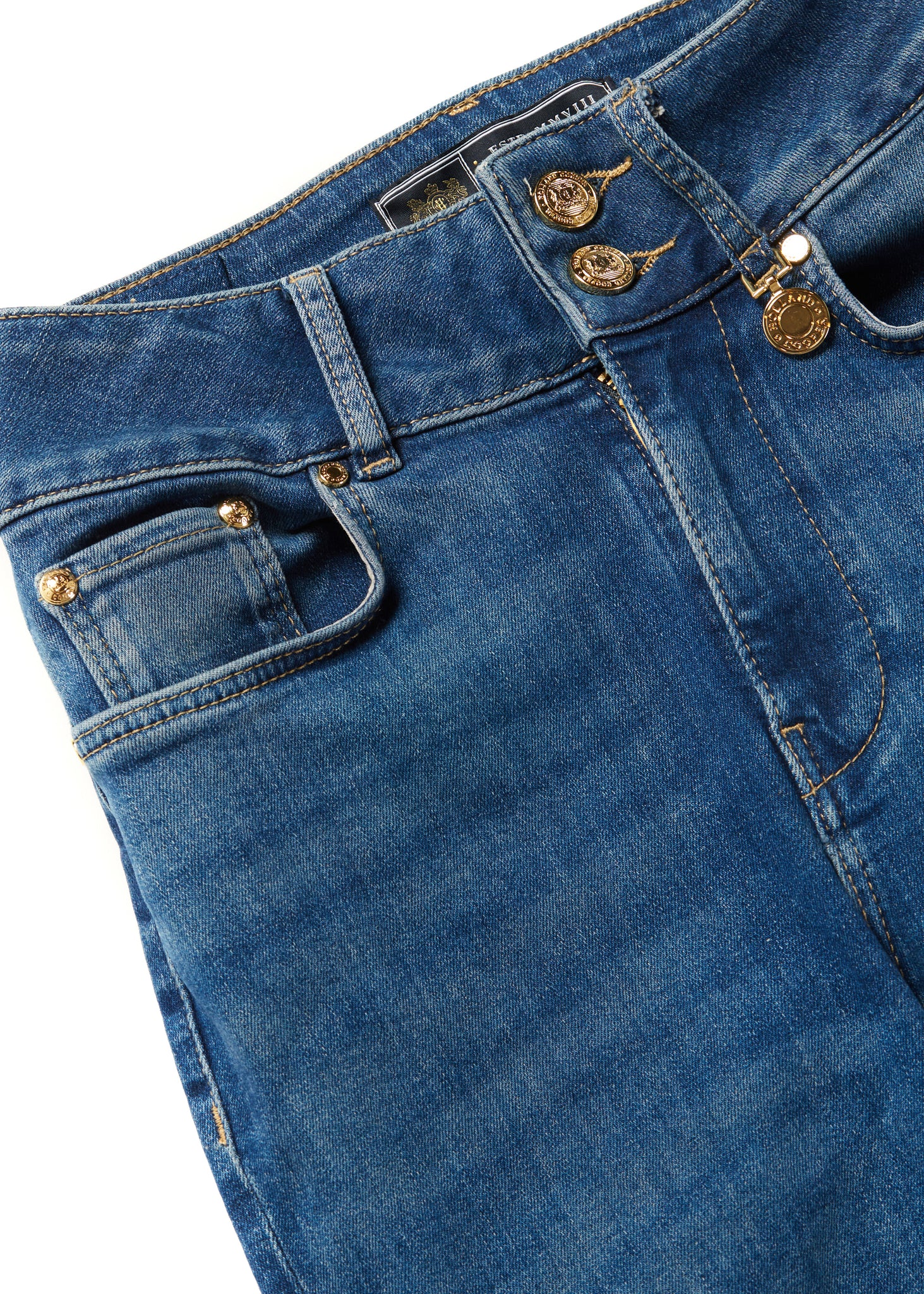 front pocket detail on womens high rise blue denim flared jean with centre front zip fly fastening with two open pockets at the front and back and gold hardware on back waistband