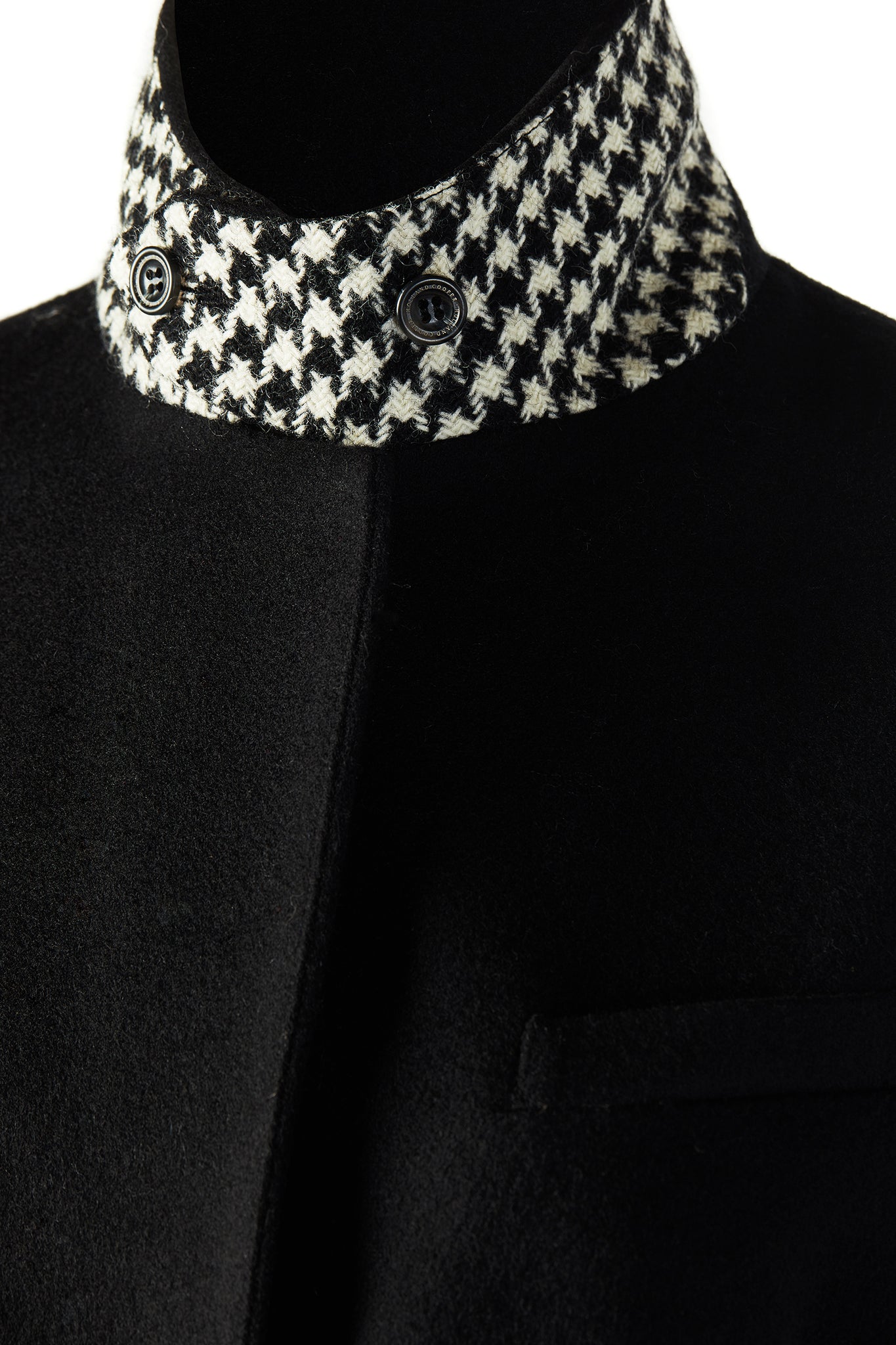 black single breasted full length wool coat with black and white houndstooth under collar detail
