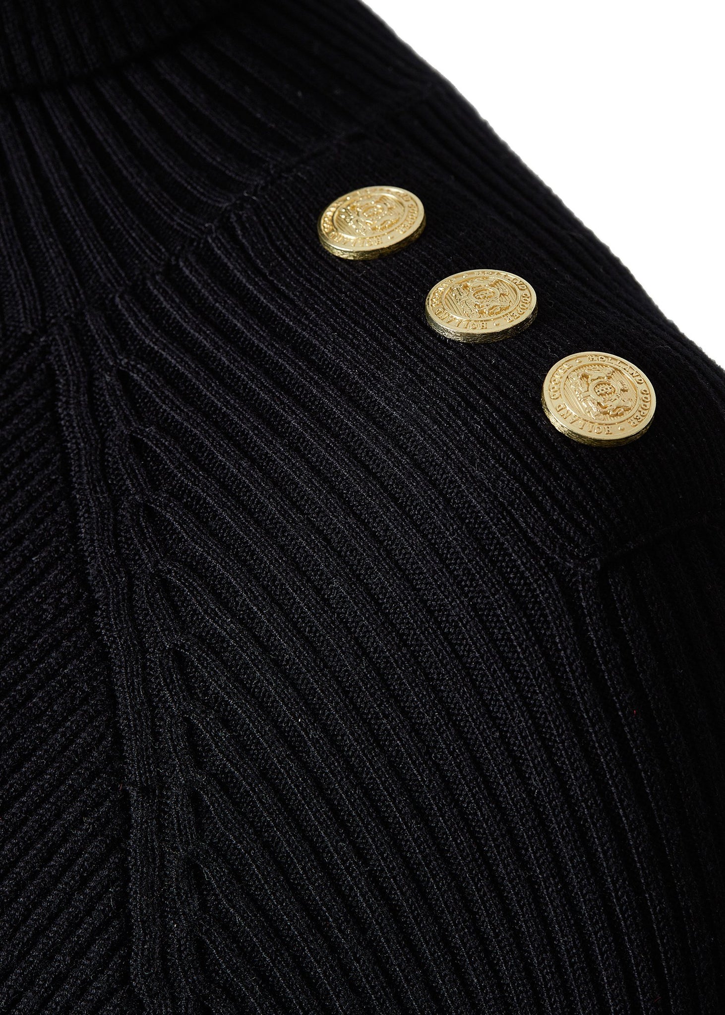 detailed shot of gold buttons on shoulder of womens black knitted roll neck midi dress 