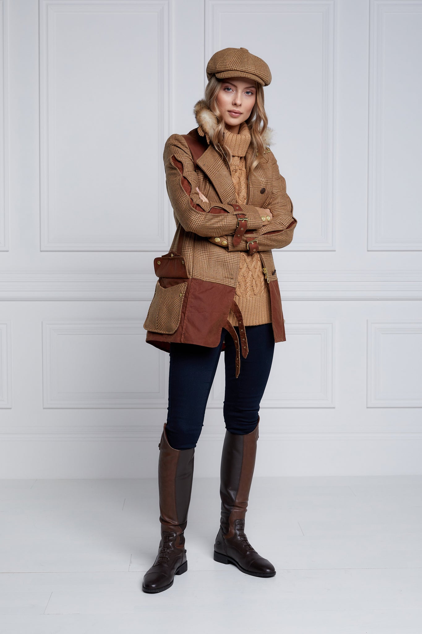 womens fitted field jacket in tawny and brown check tweed trimmed with contrast tan wax fabric on shoulder across back and on the hip with faux fur trim around the neck finished with horn button fastenings an buckles on the collar cuffs and hip