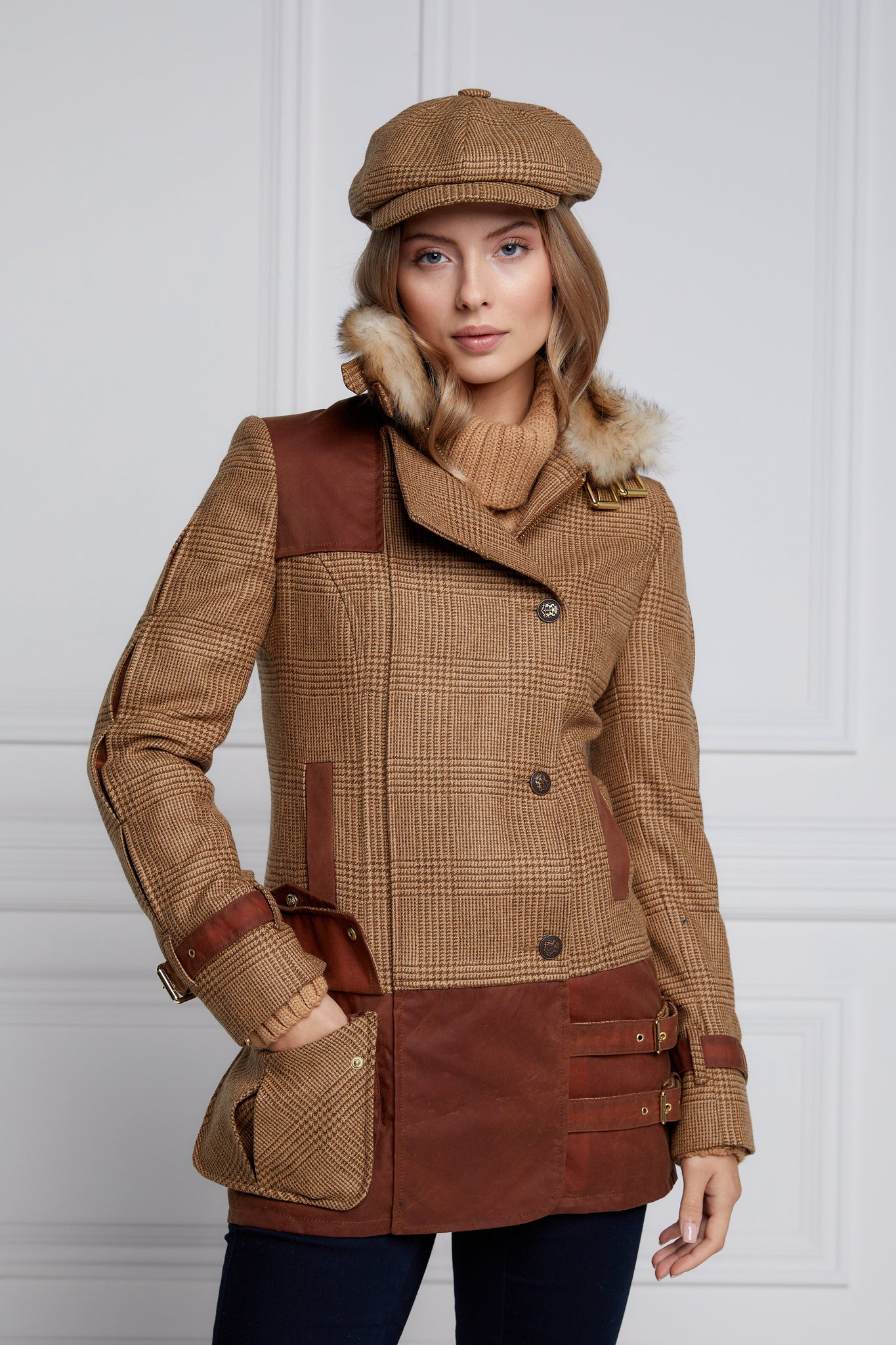  womens fitted field jacket in tawny and brown check tweed trimmed with contrast tan wax fabric on shoulder across back and on the hip with faux fur trim around the neck finished with horn button fastenings an buckles on the collar cuffs and hip