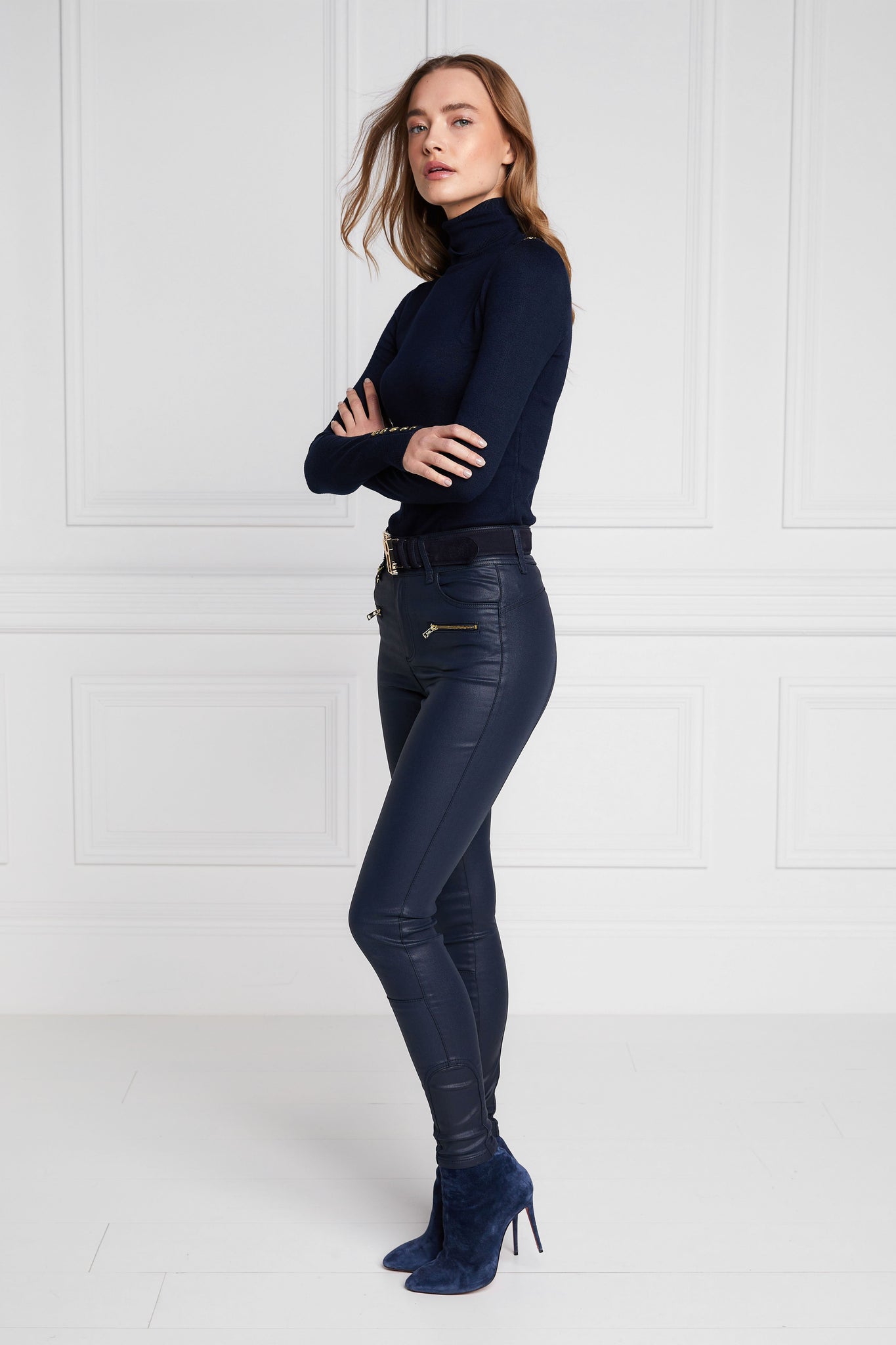 side of womens high rise blue coated skinny jean for a waxed look with jodhpur style seams with two open zip pockets to the front with HC branded pulls