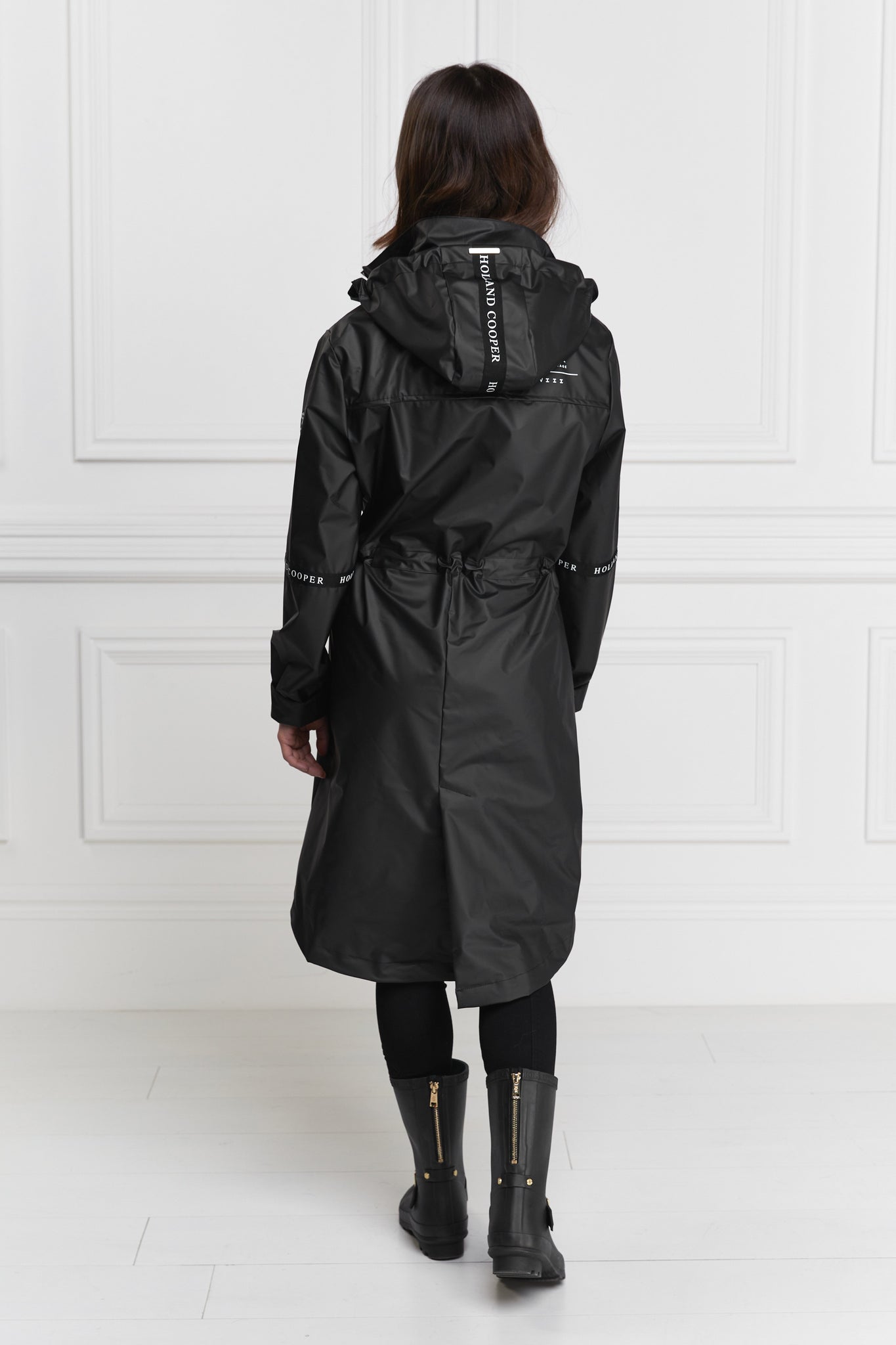 back of womens matte black rain coat with hood 