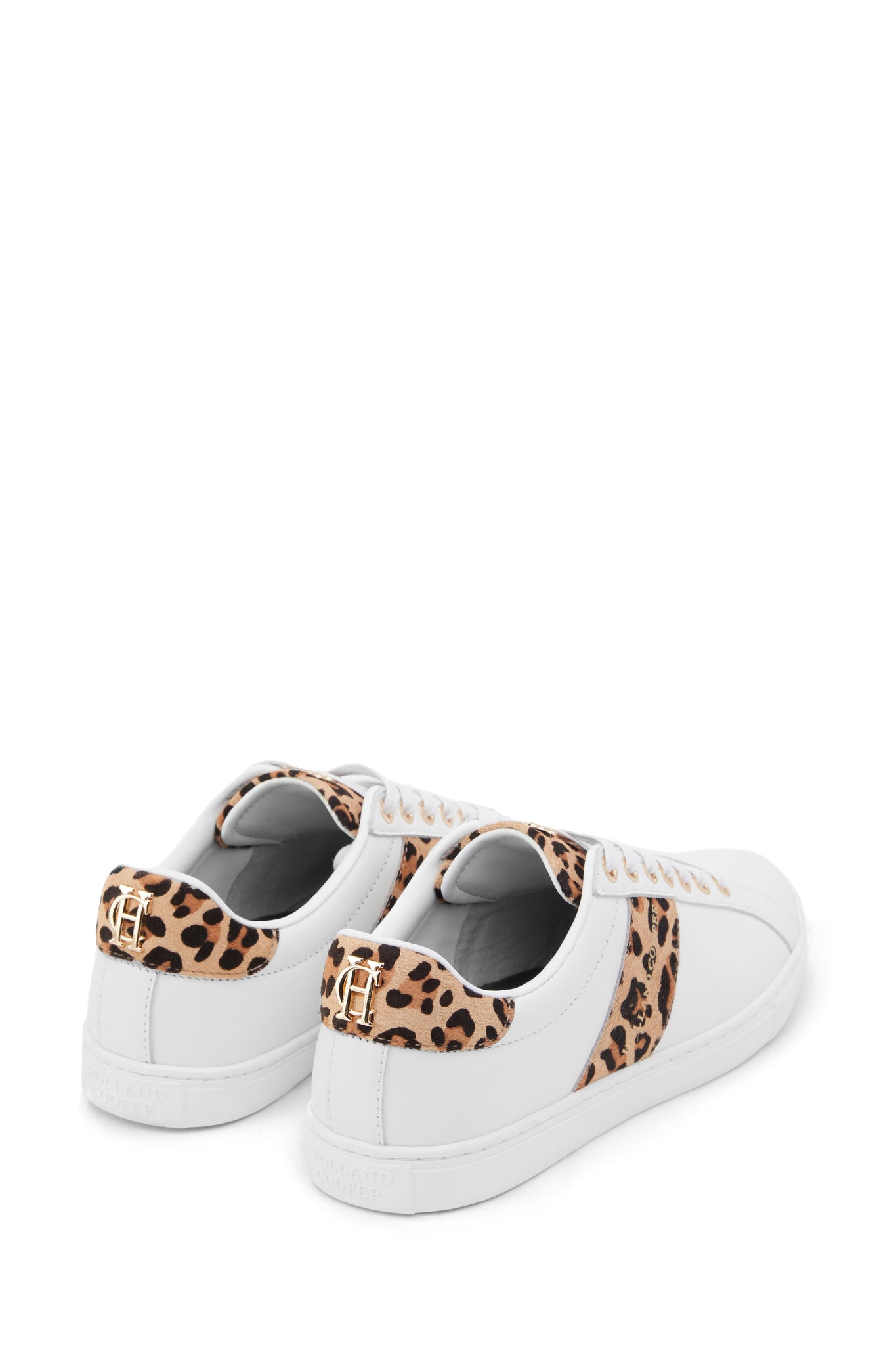 Back of white leather trainers with white laces detailed with a diagonal stripe of leopard print on the side with gold foil branding and a leopard print heel and tongue with gold hardware