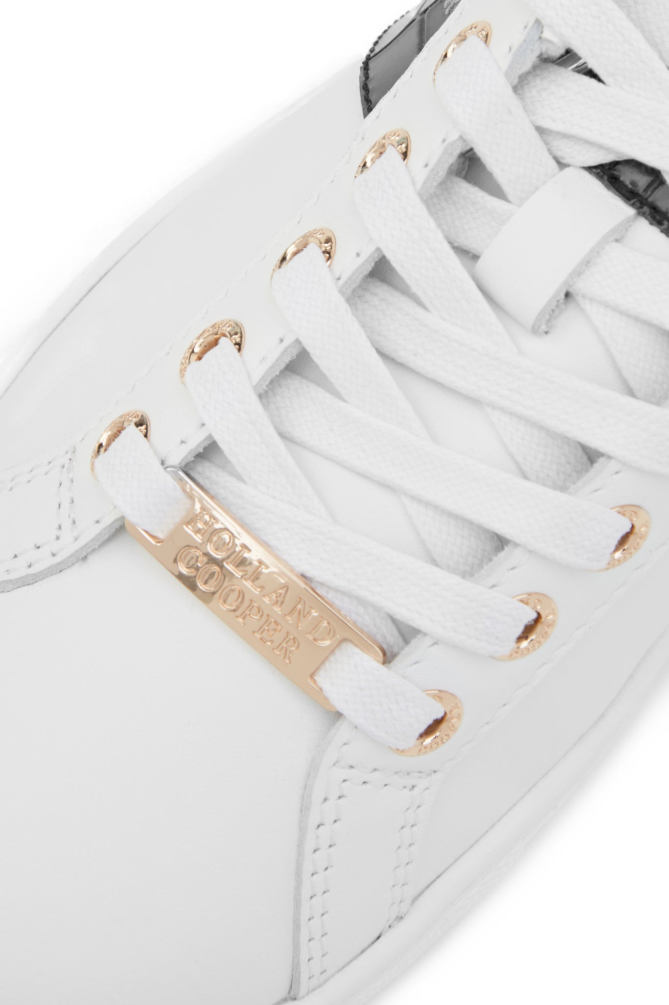 Close up of the white laces with gold hardware