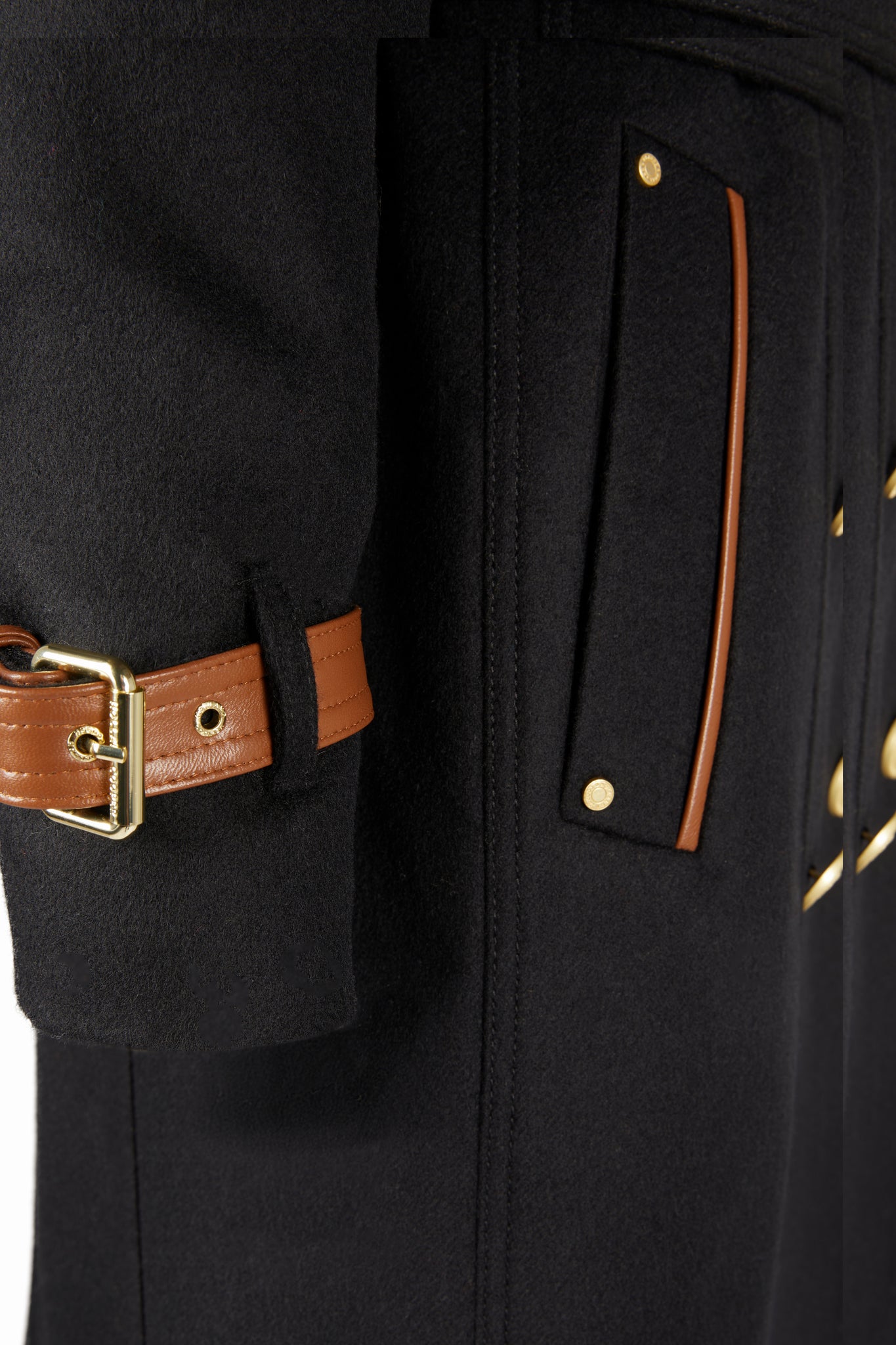 Arm detail of Womens black and tan brown leather detailed with gold hardware knee length wool trench coat