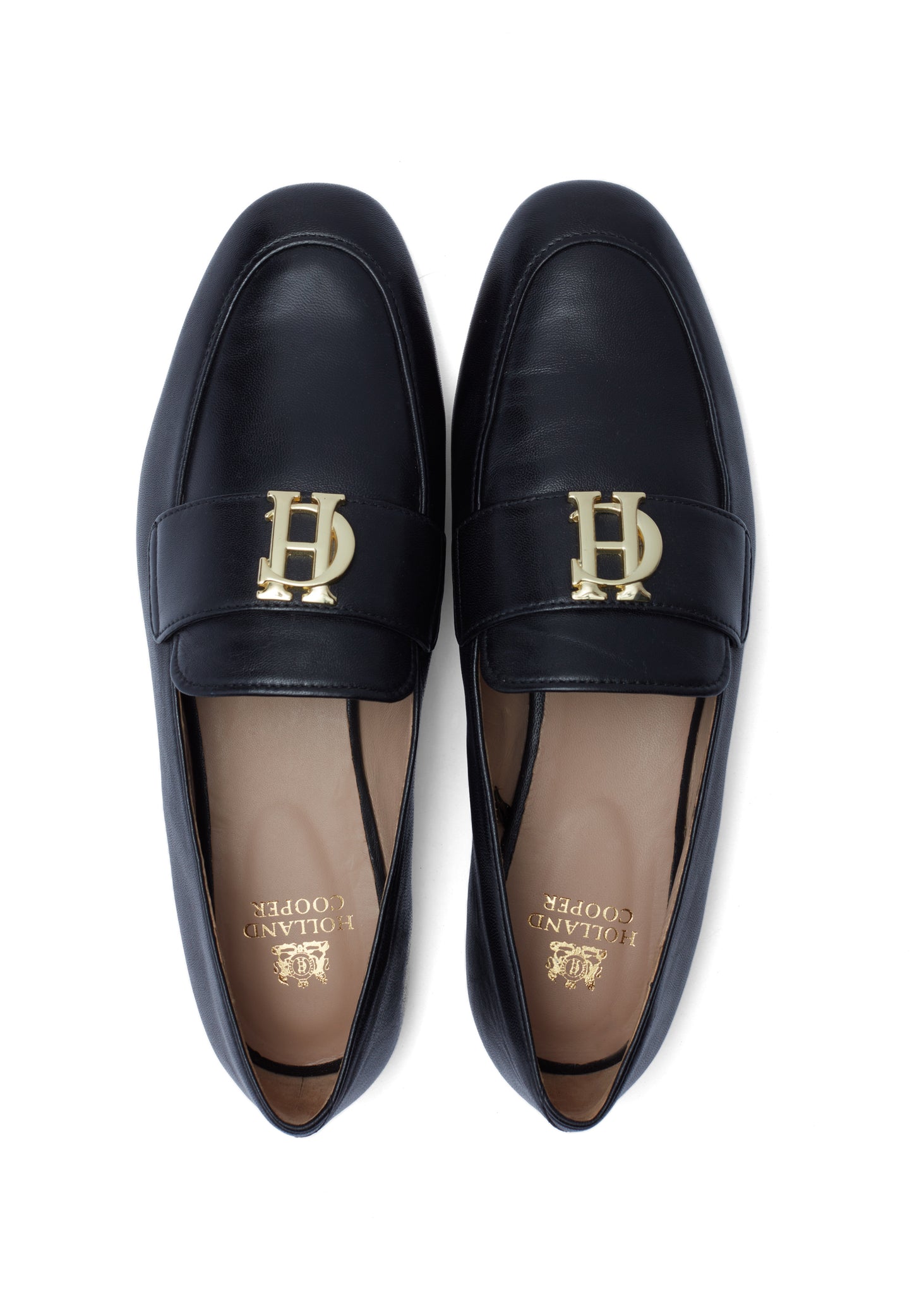 birds eye view of black leather loafers with a slightly pointed toe and gold hardware to the top and gold foil branding to the inner sole