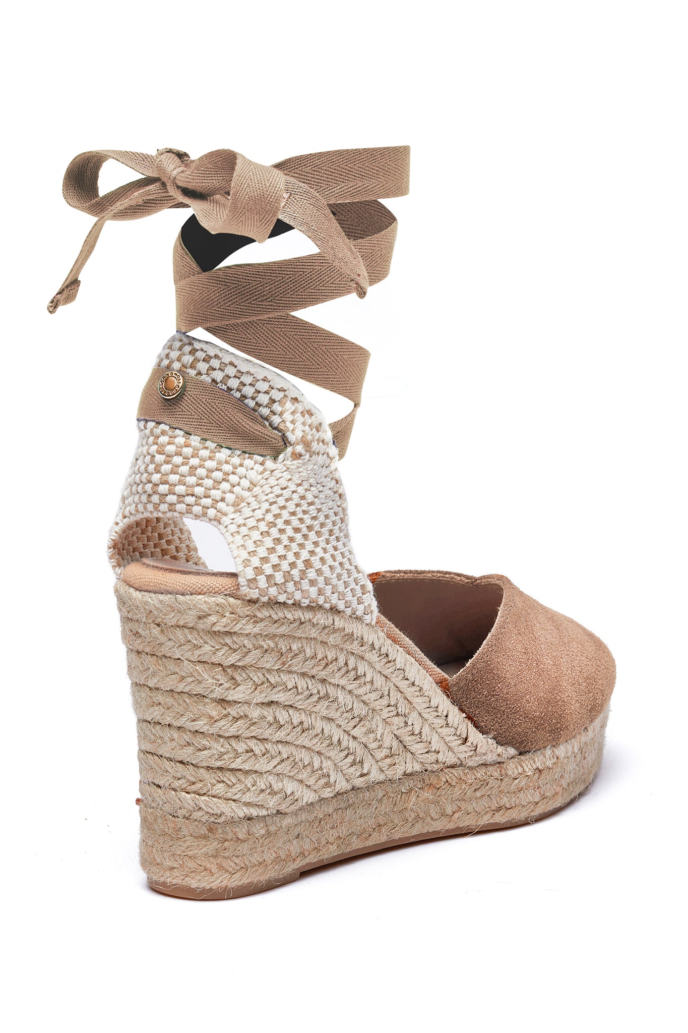 Back of 4 inch braided jute wedge heel with taupe suede top and tie up taupe ribbons around the ankle with gold hardware to the back of the ribbon