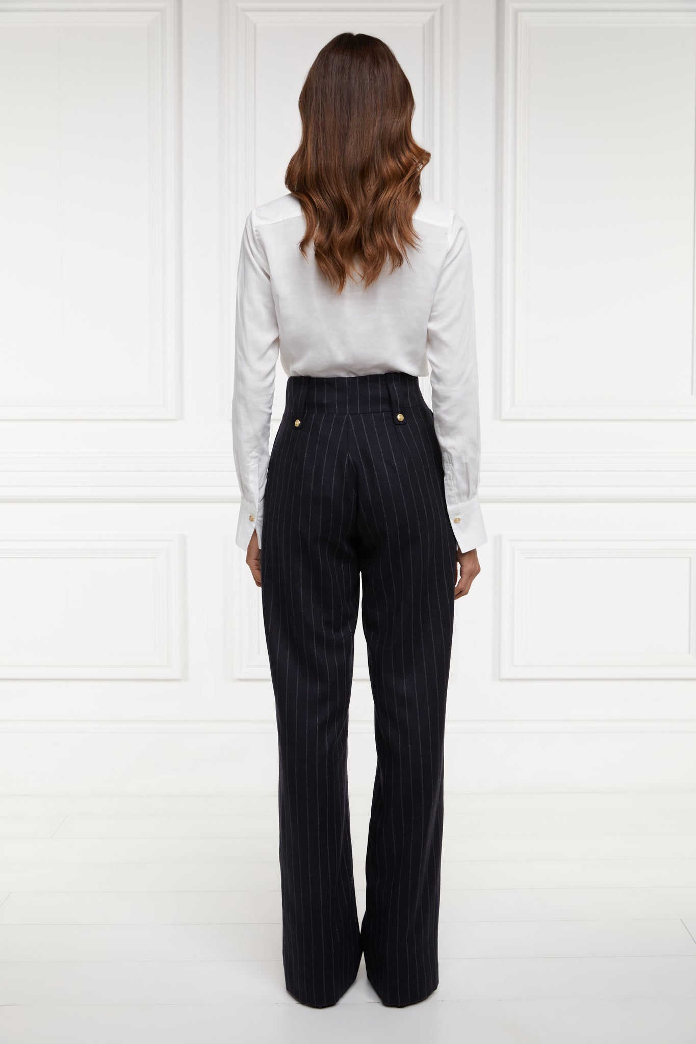 Back of Womens navy chalk pin stripe wool high waisted straight trousers with classic white shirt