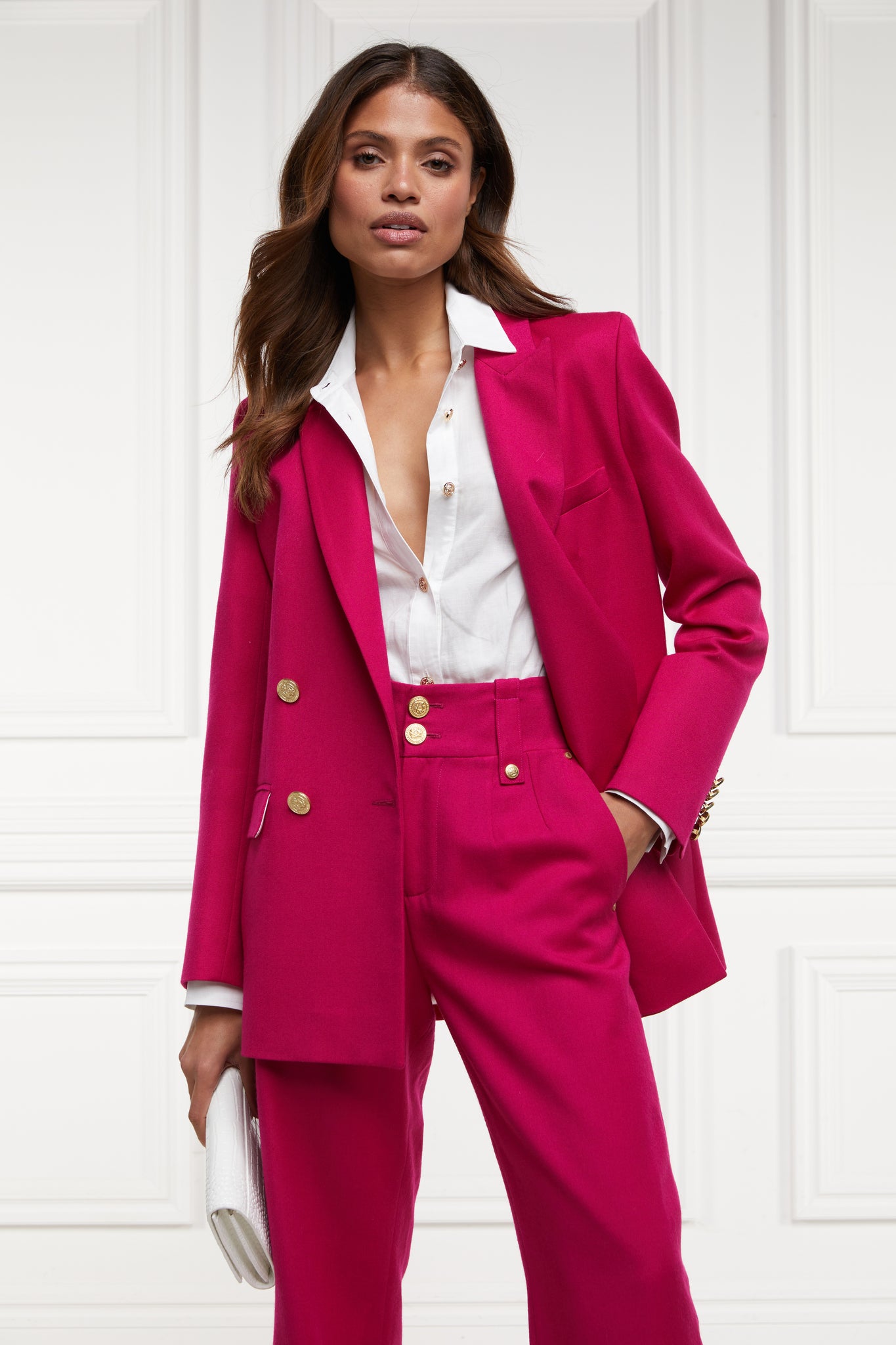 longline double breasted wool blazer in hot pink tailor made in britain with relaxed fit welt pockets and gold buttons on the front and cuffs