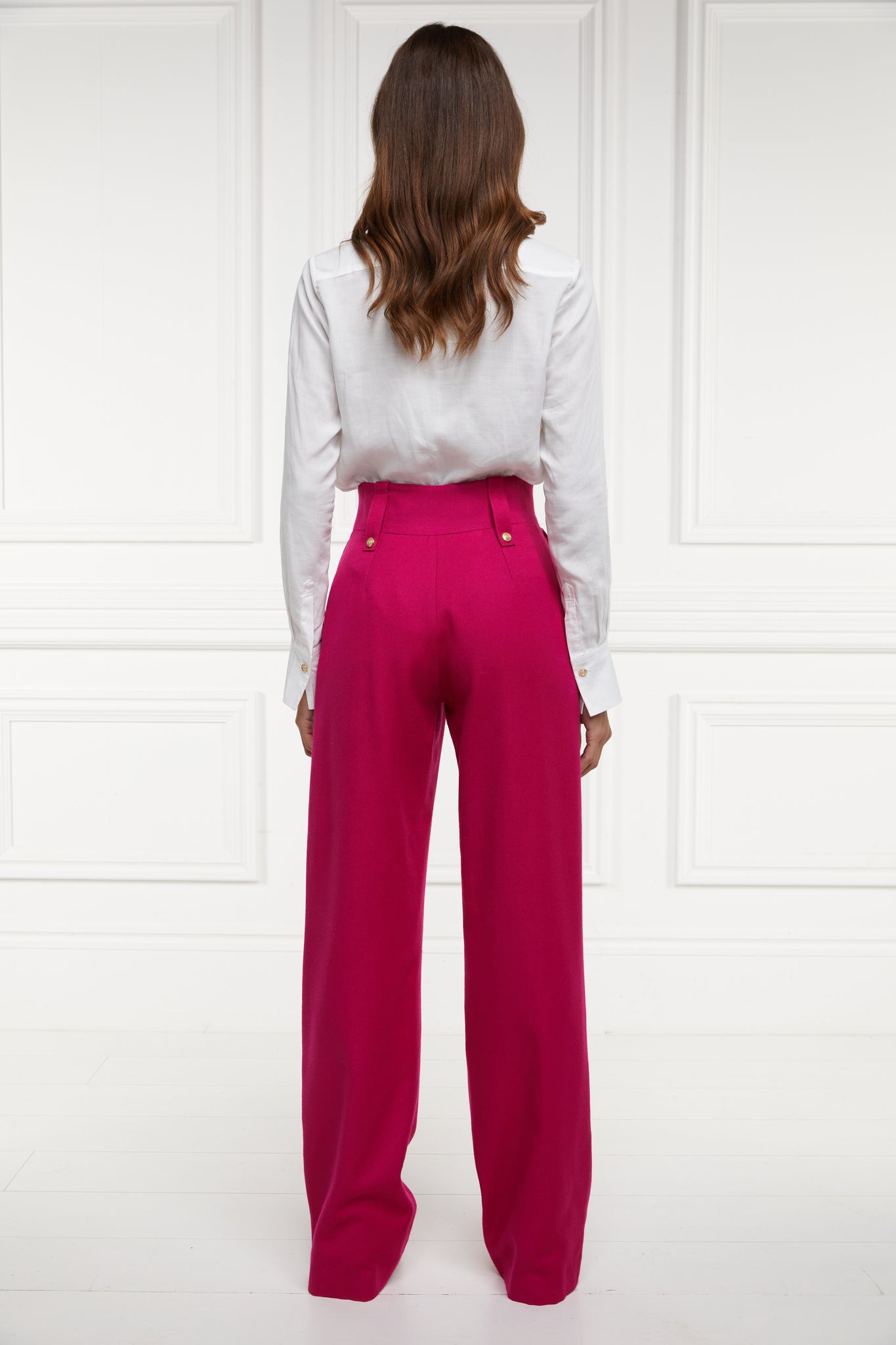 Back of Women's hot pink wool high waisted straight trousers with classic white shirt 