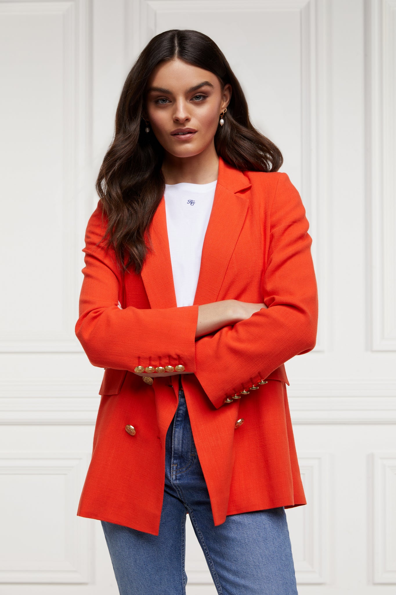double breasted linen blazer in orange with two hip pockets and gold button detials down front and on cuffs and handmade in the uk worn with white tee and light blue denim jeans