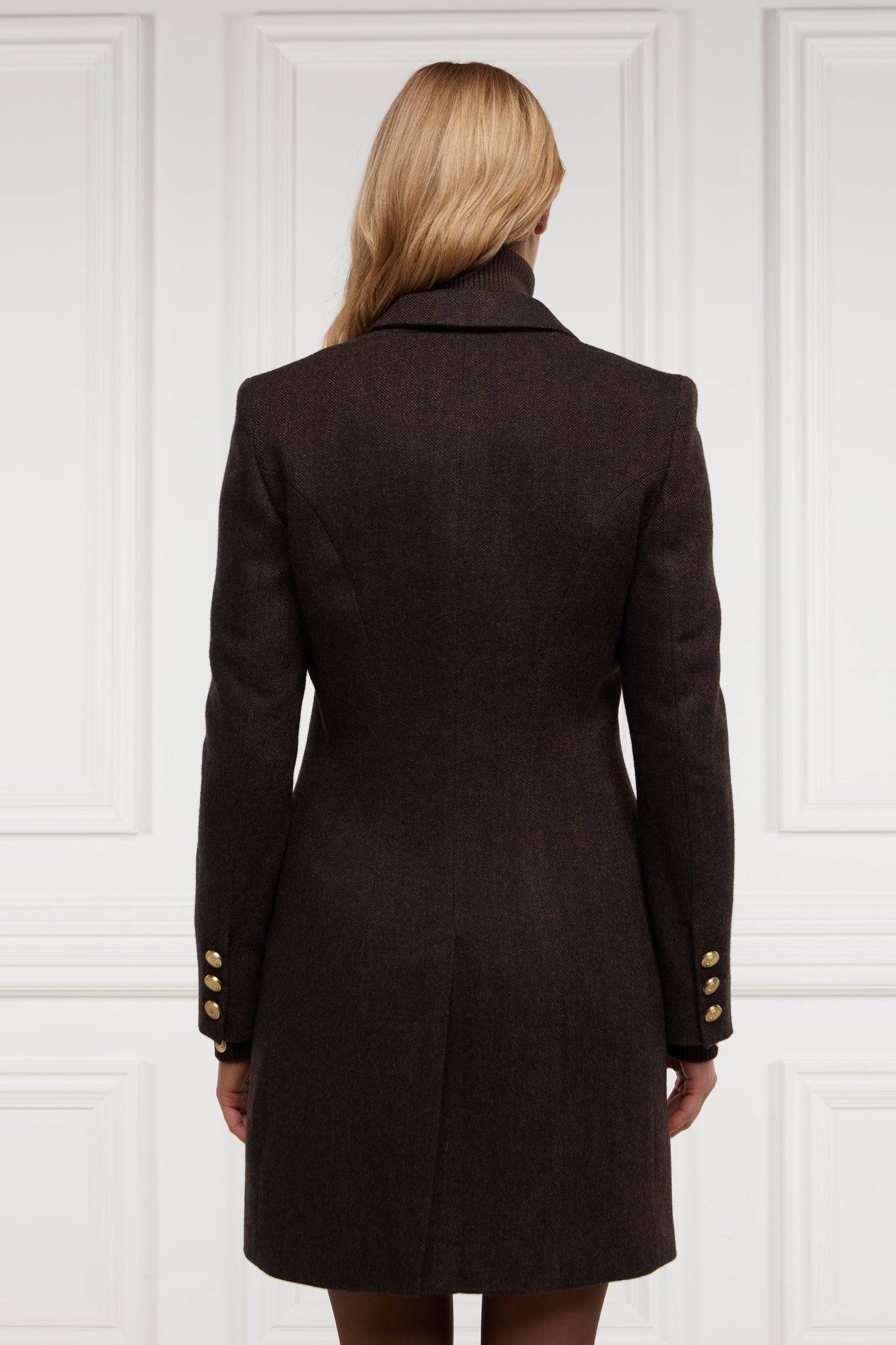 back of womens dark brown herringbone tweed mid-length single breasted coat detailed with gold hardware