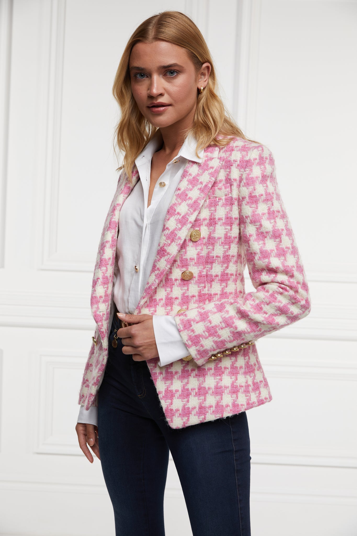 pink and white large scale houndstooth fitted blazer double breasted style but with only single button fastening to the one central button for more form fitted tailored look finished with two pockets at hips and gold button details on front and cuffs