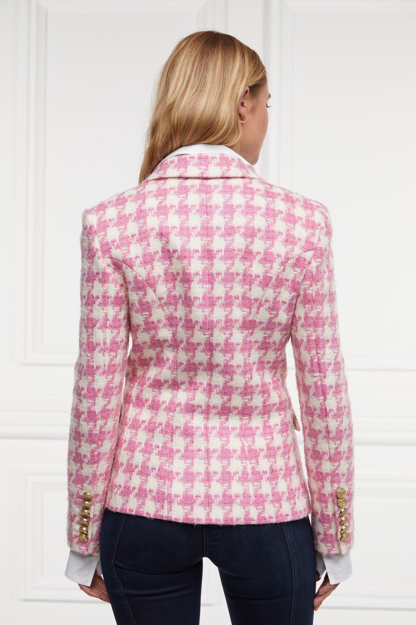 back of pink and white large scale houndstooth fitted blazer double breasted style but with only single button fastening to the one central button for more form fitted tailored look finished with two pockets at hips and gold button details on front and cuffs