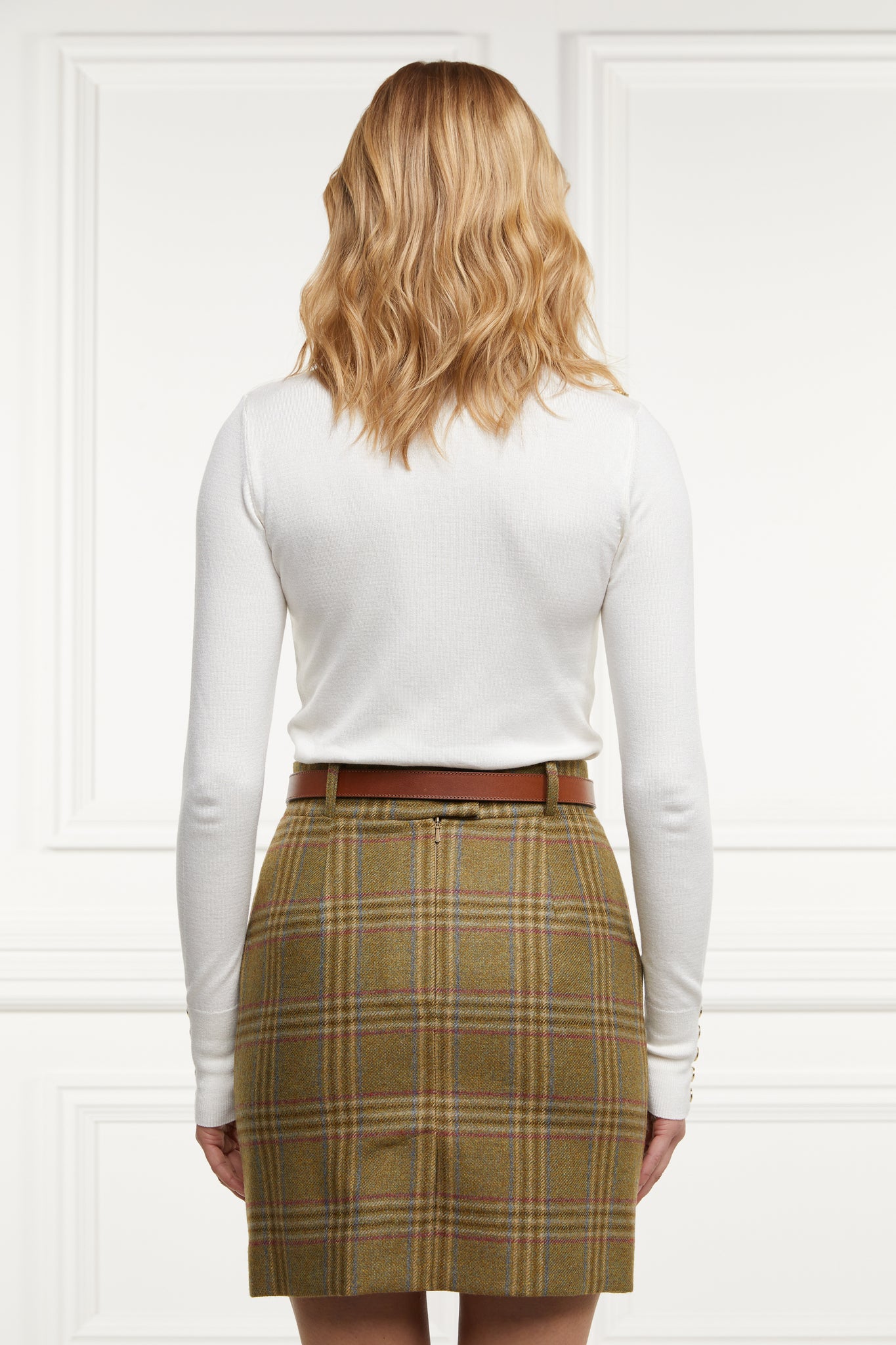 back of womens wool pencil mini skirt in green check with concealed zip fastening on centre back with gold hc button above zip