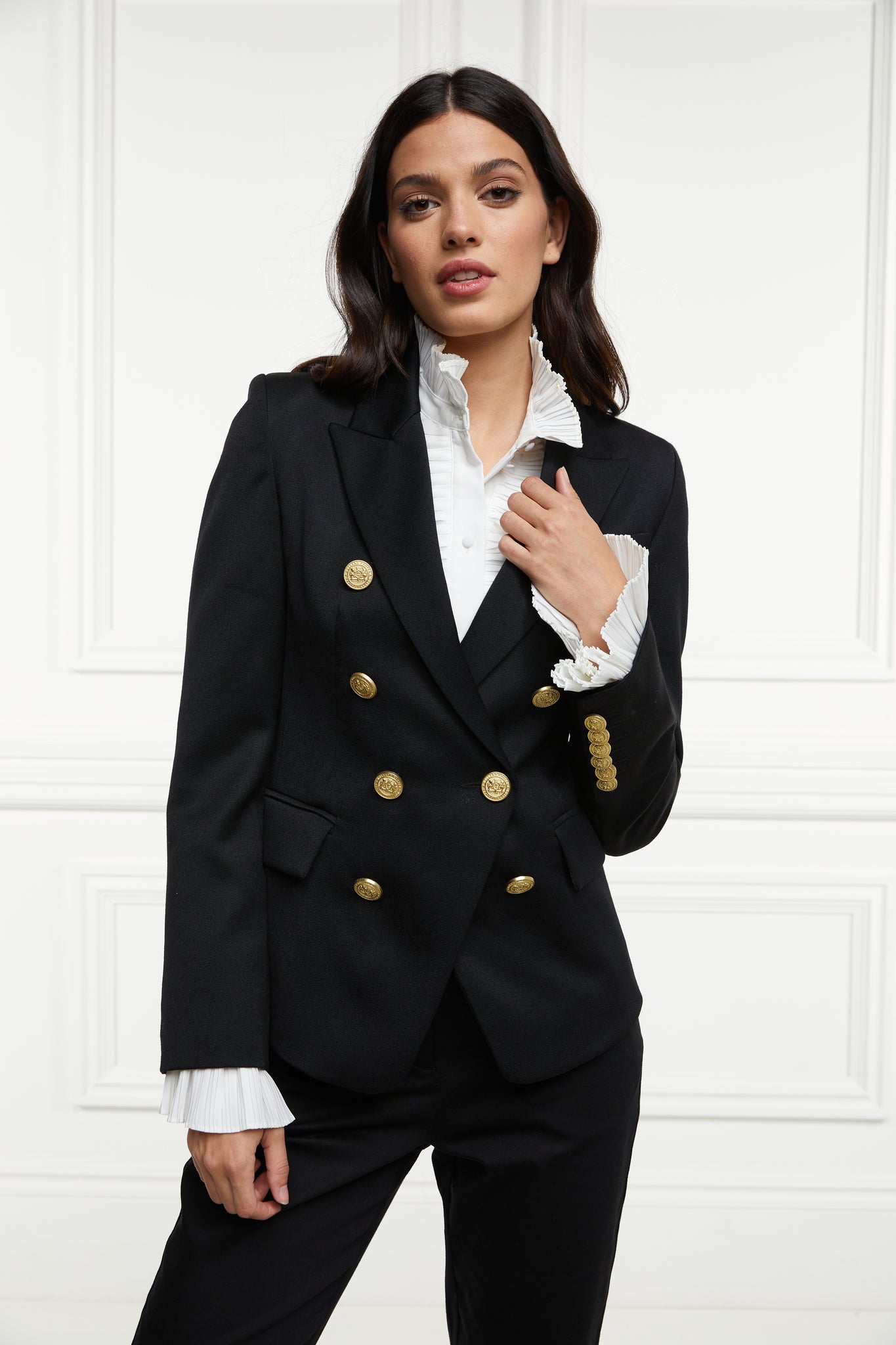 British made double breasted blazer that fastens with a single button hole to create a more form fitting silhouette with two pockets and gold button detailing this blazer is made from black barathea