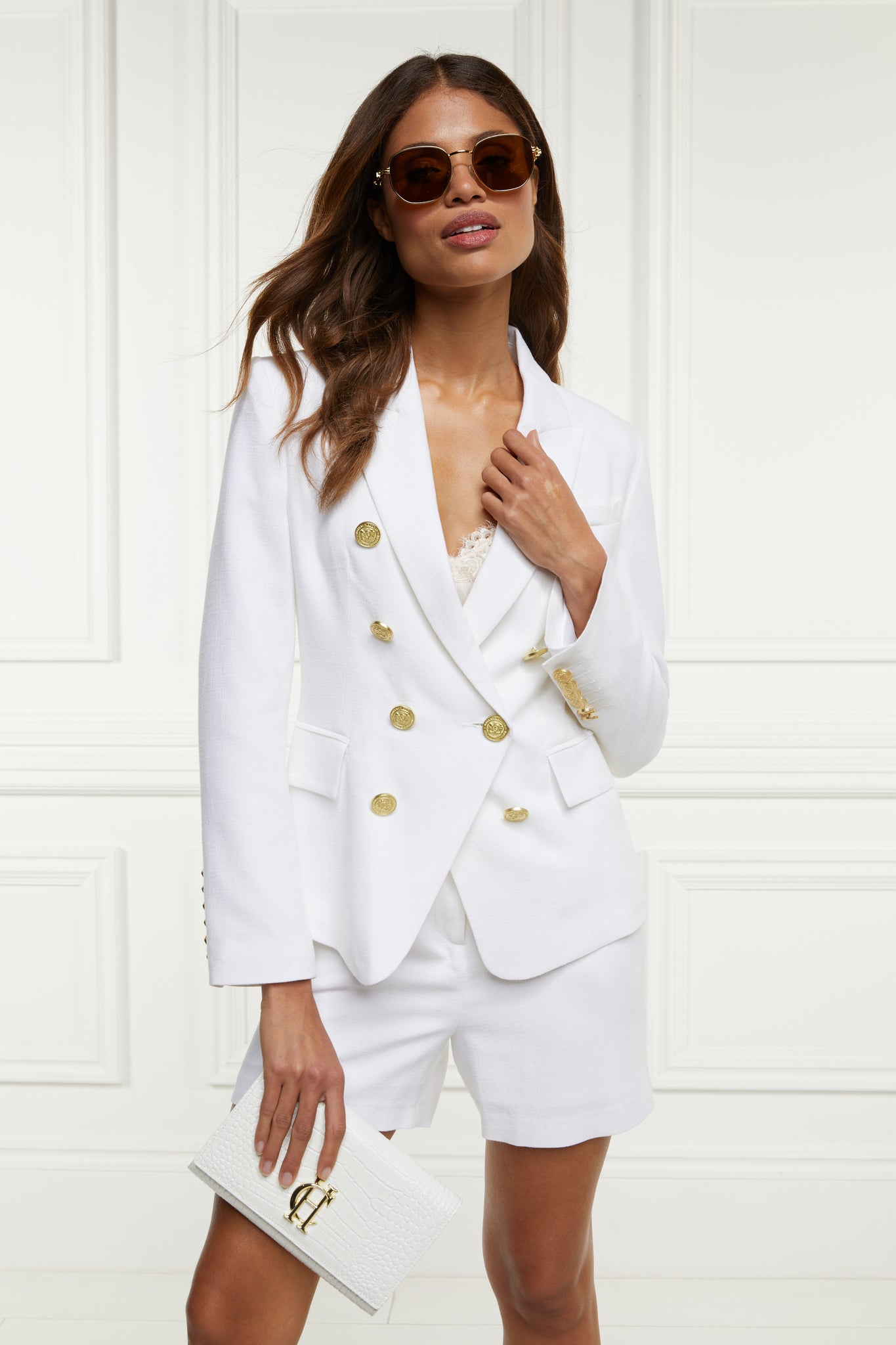 British made double breasted blazer that fastens with a single button hole to create a more form fitting silhouette with two pockets and gold button detailing this blazer in white linen