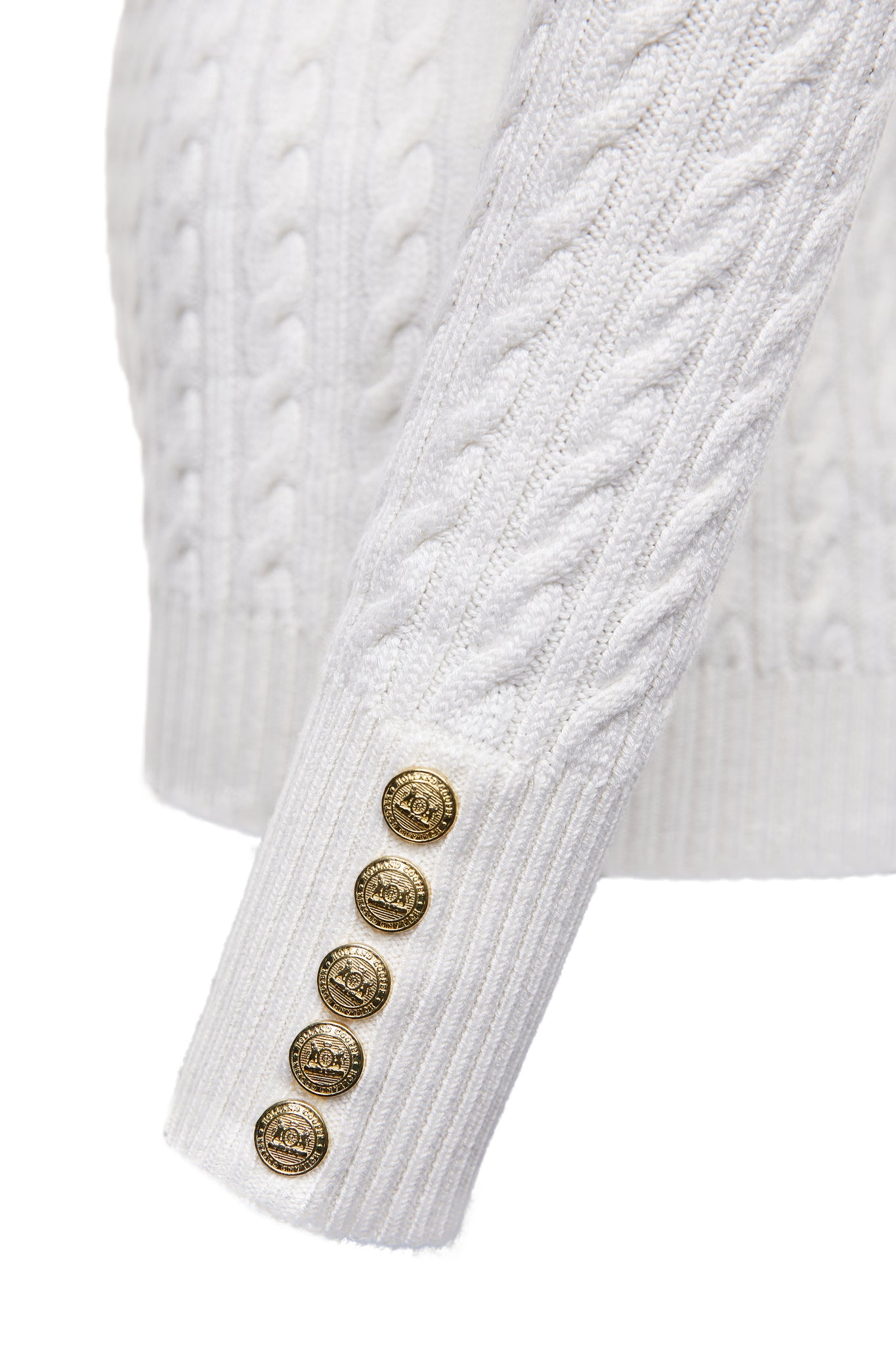 gold button detail on cuffs of womens cable knit jumper in white with ribbed crew neck cuffs and hem