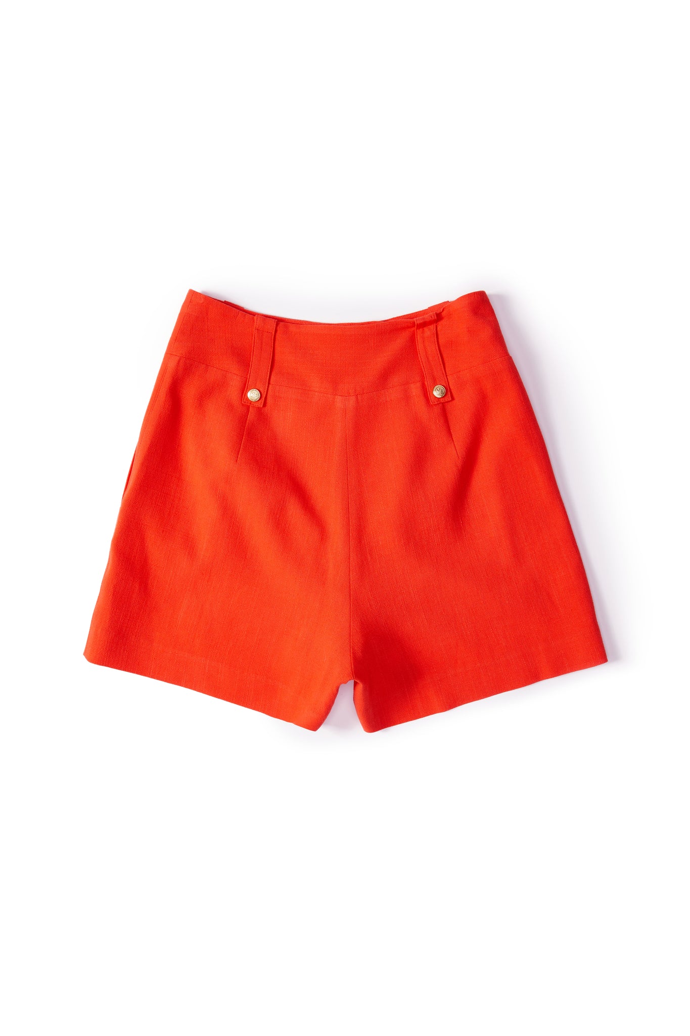 back of womens orange linen tailored shorts with two single knife pleats and centre front zip fly fastening with two gold stud buttons