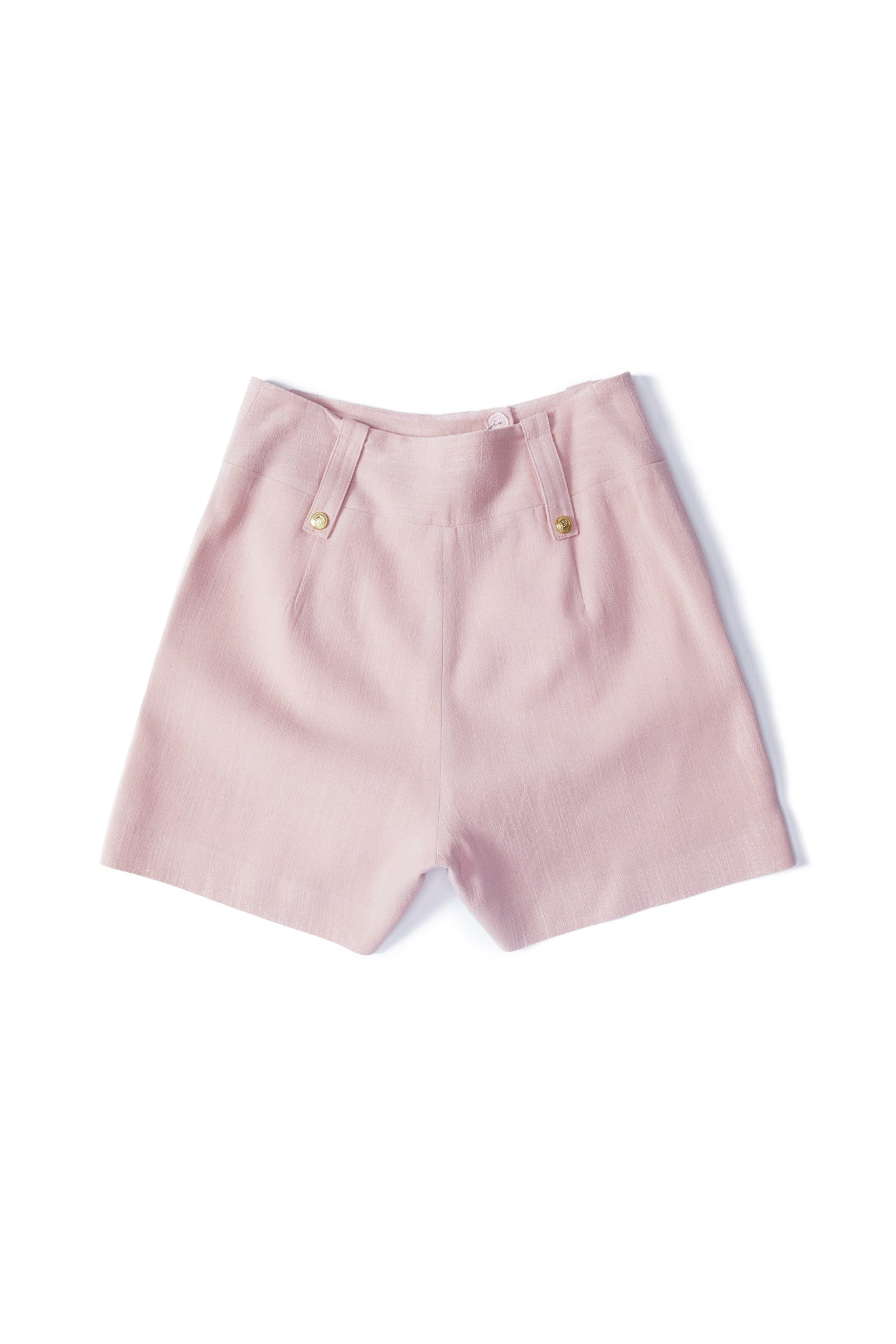 back of womens light pink linen tailored shorts with two single knife pleats and centre front zip fly fastening with two gold stud buttons