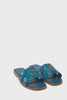 360 video of teal blue croc embossed leather sliders with  a tan leather sole and gold hardware.