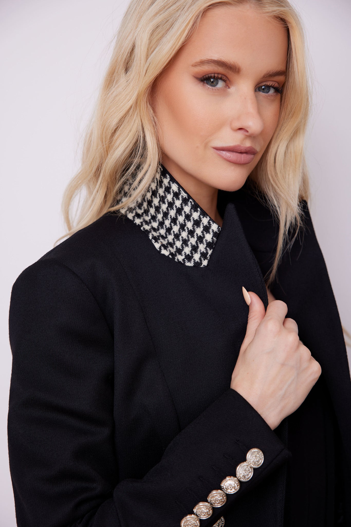 British made tailored cropped jacket in black with welt pockets and gold button detail down the front and on sleeves with black and white houndstooth undercollar